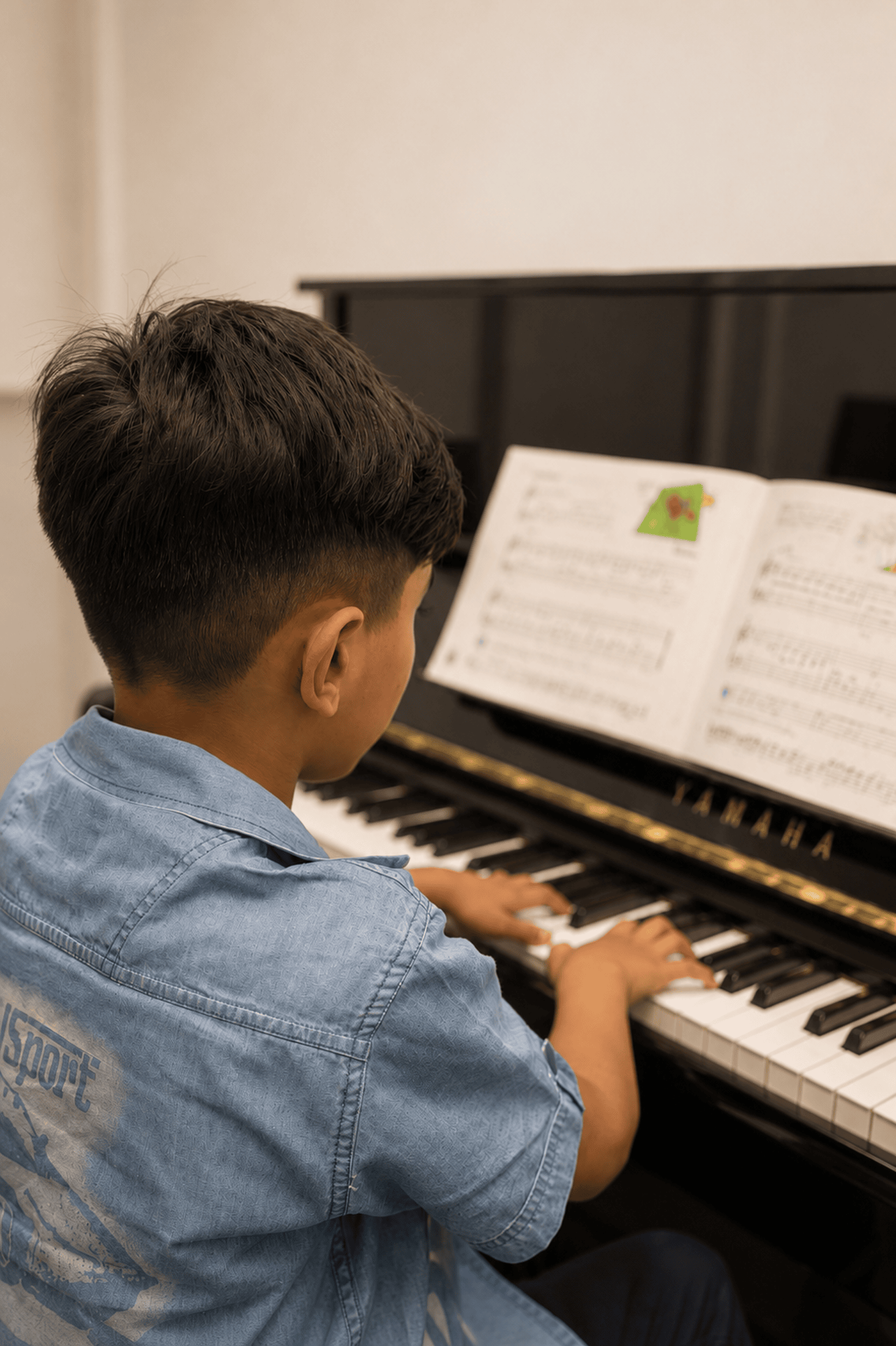 Young student practicing piano with sheet music