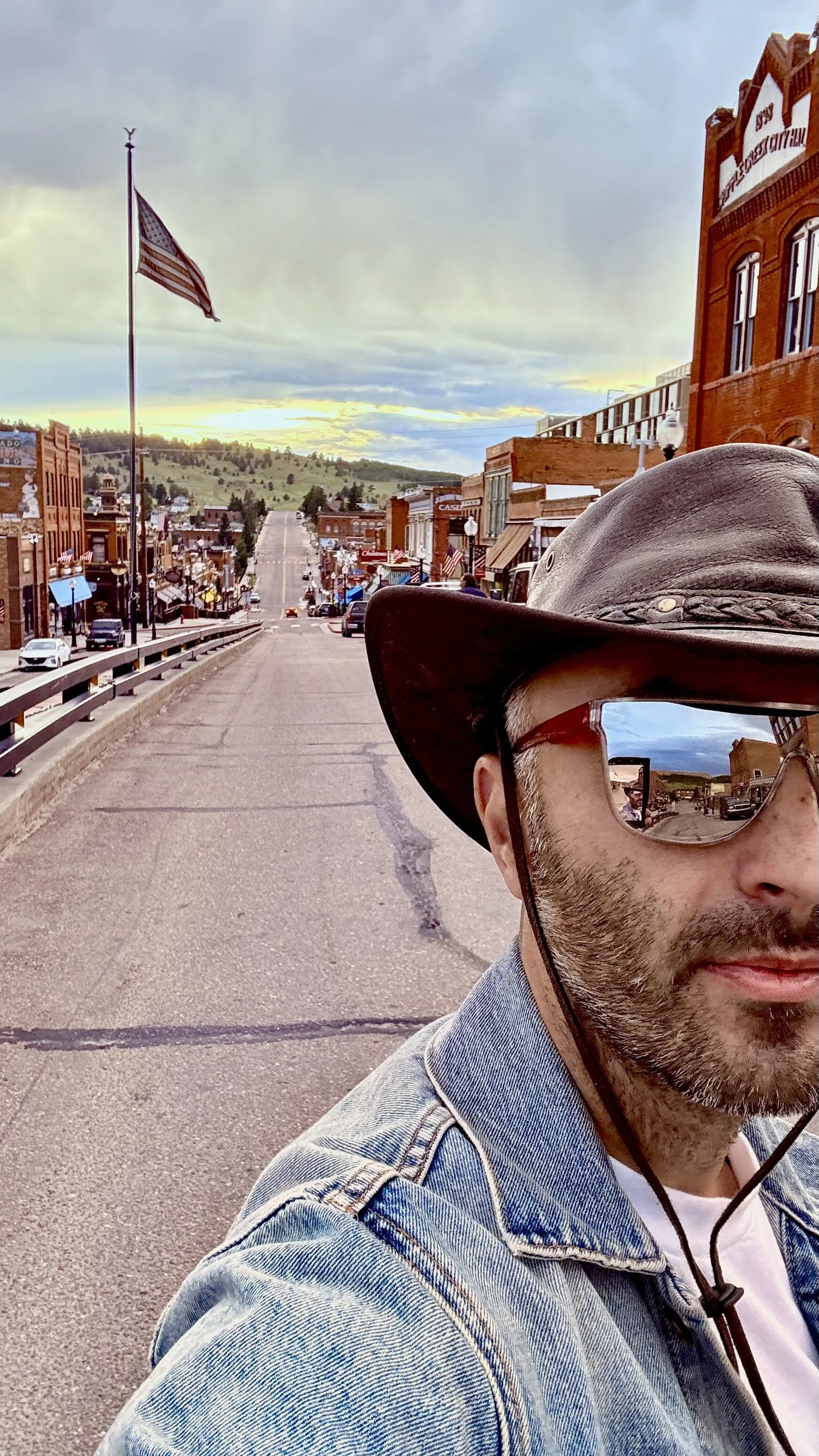 Man in denim jacket stands in Cripple Creek, Co.