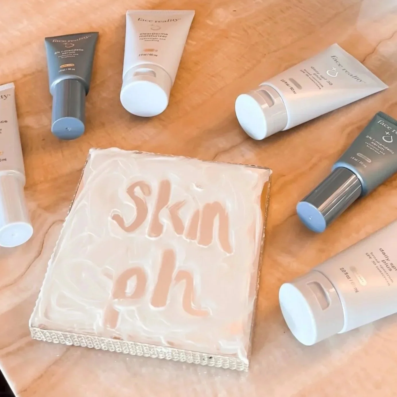 Several skincare products including tubes of Face Reality, and a soap bar with