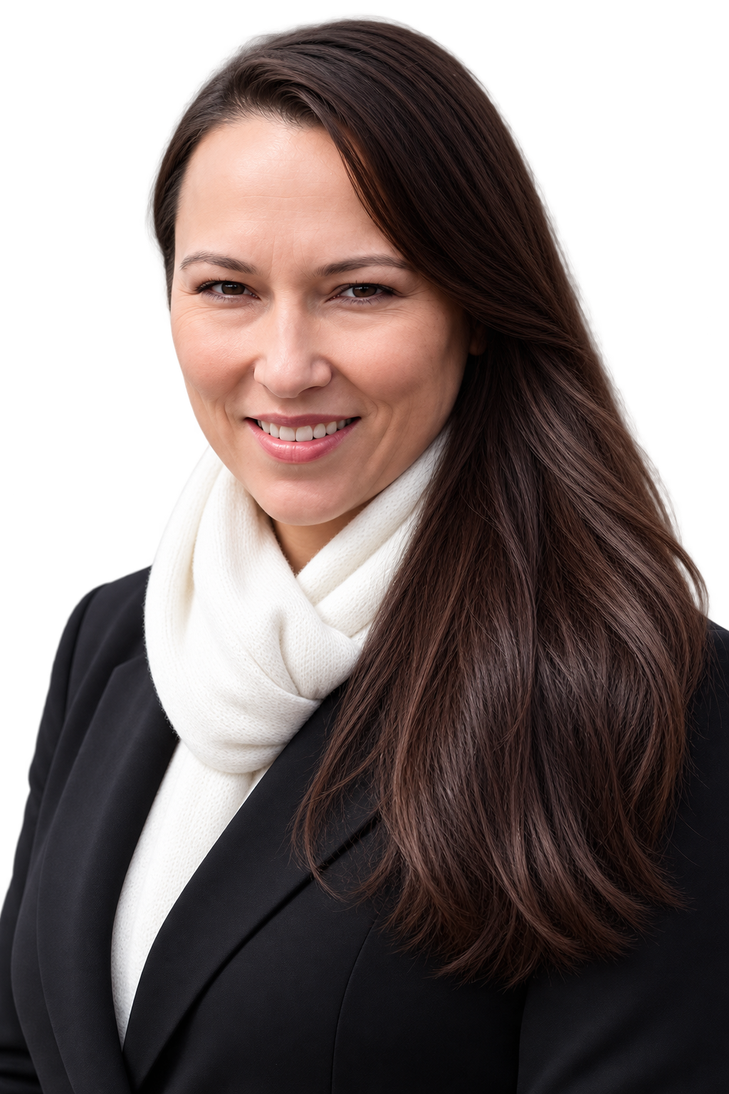 A woman with long brown hair wearing a black blazer and a white scarf, smiling at the camera in an outdoor setting.