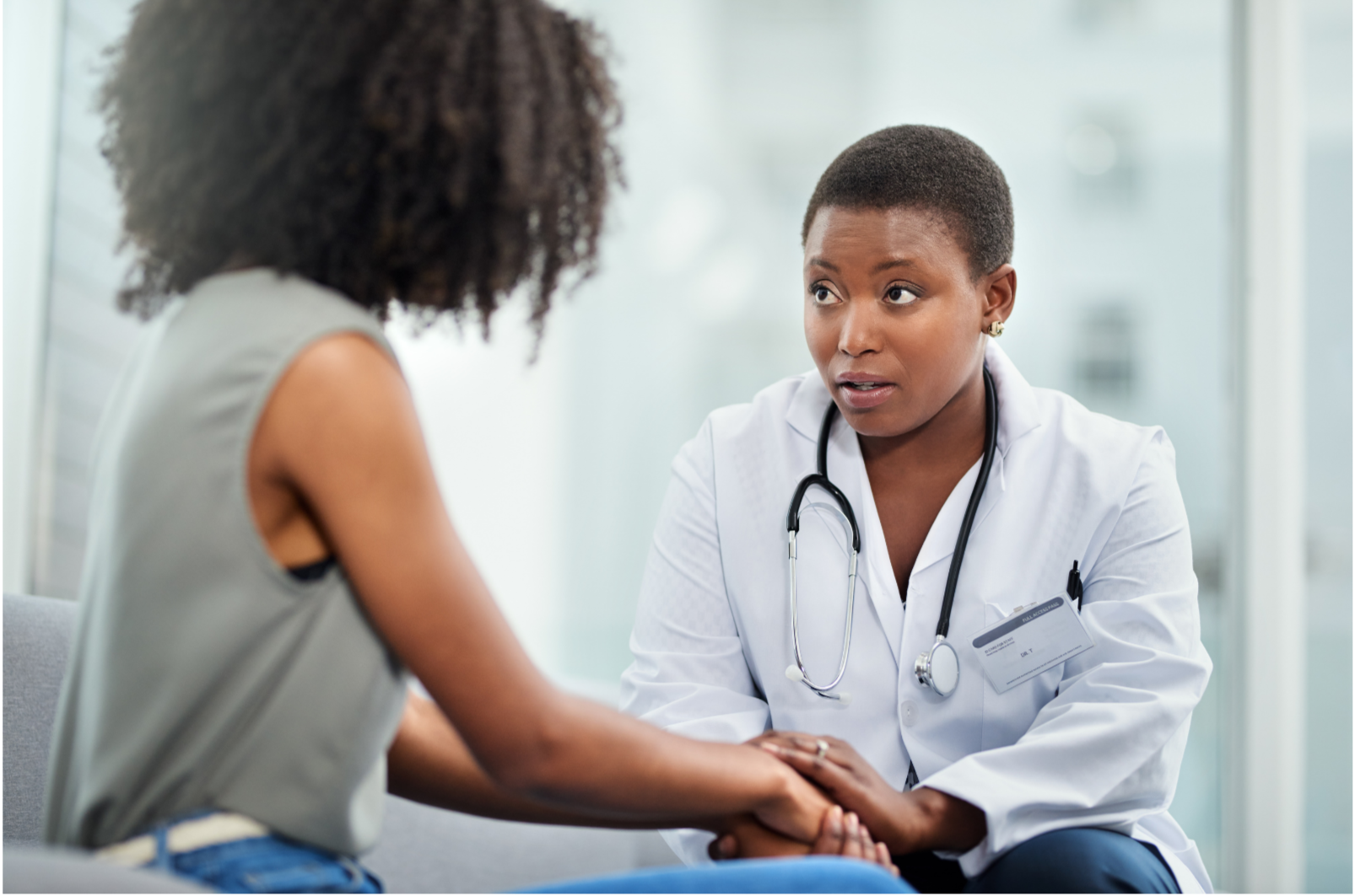 Medical professional, woman with stethoscope, talking to patient in clinic or hospital setting.