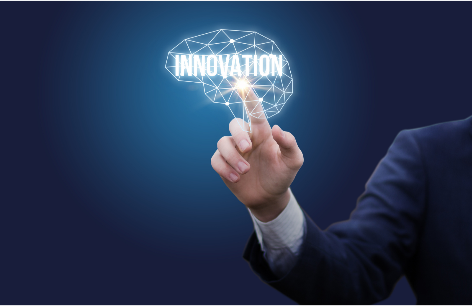 Person in a suit using a finger to interact with a digital graphic of a brain with the word 'INNOVATION' inside it, representing technology and innovation.