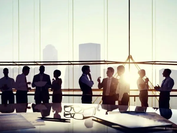 Team of business professionals having a meeting or discussion in a modern office.
