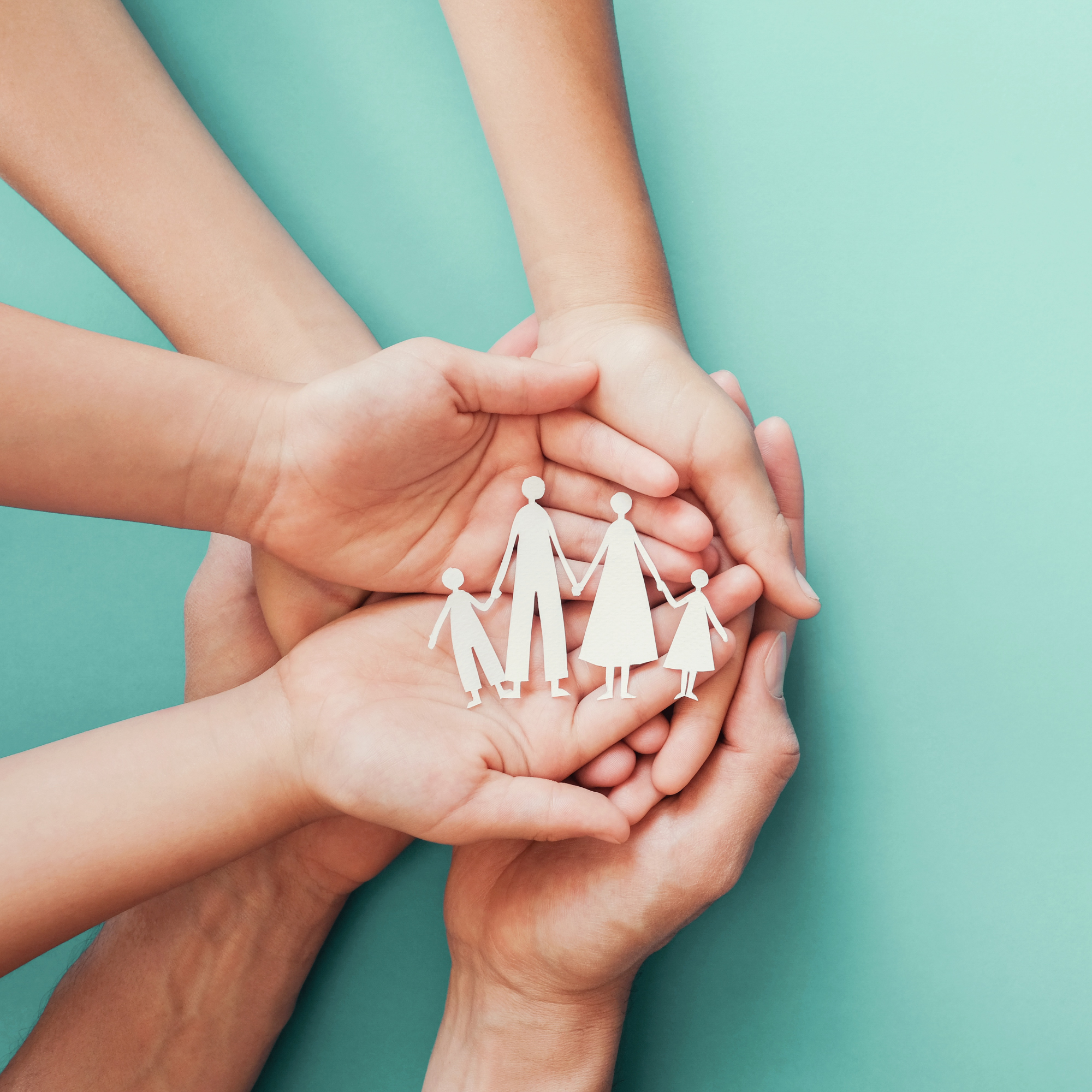 Multiple hands holding paper cutouts of a family figure against a light blue background.