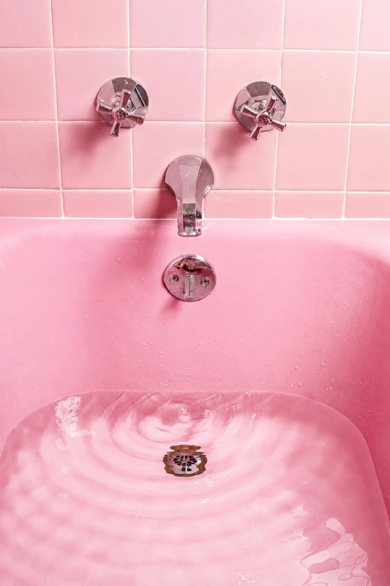 a vintage pink bathtub is shown as part of a mid century modern bathroom design