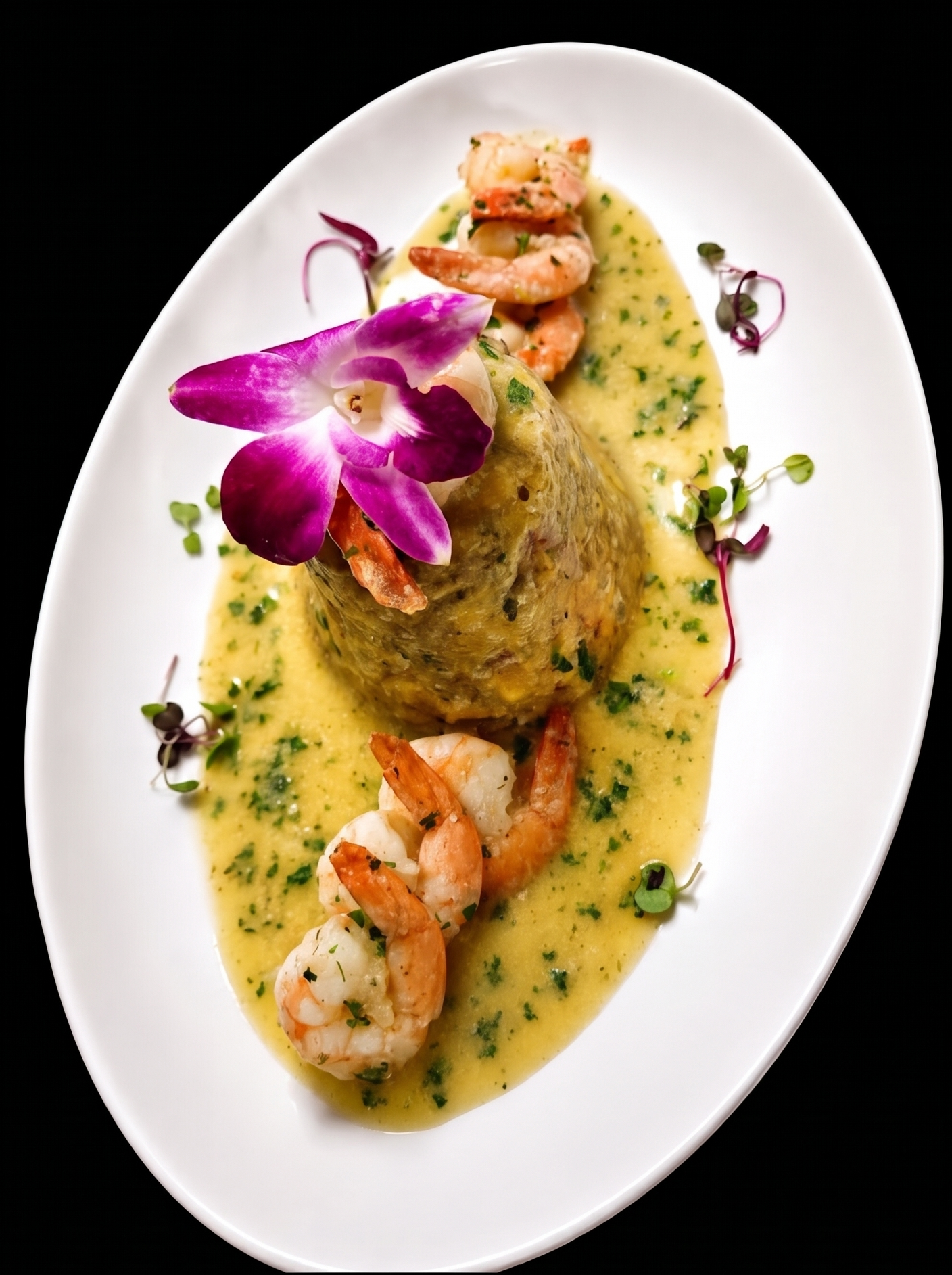 A white oval plate with a seafood dish featuring a baked fish fillet topped with shrimp, surrounded by a creamy yellow sauce with herbs, garnished with an orchid flower and microgreens.