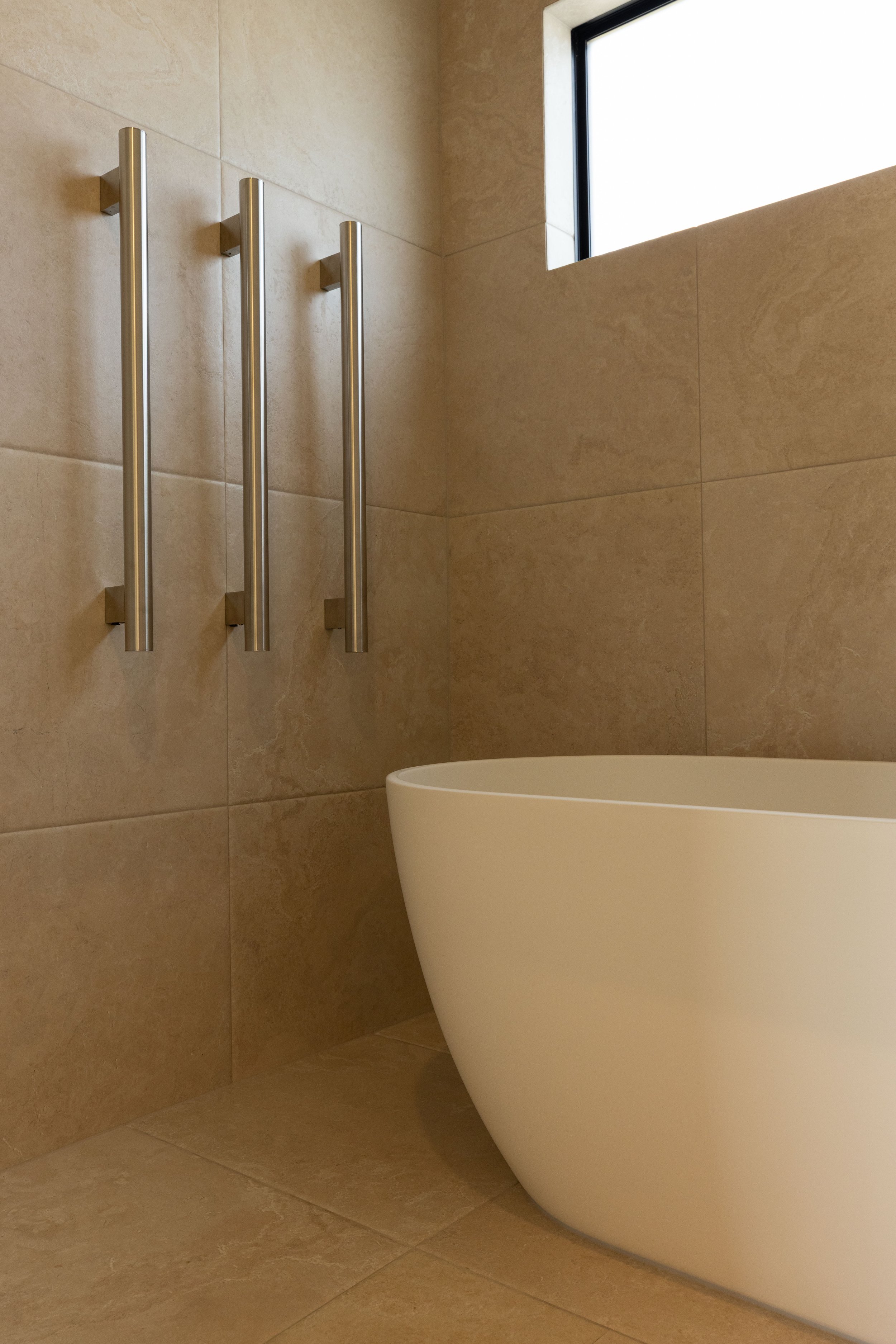 Modern bathroom in completed Benchmark Build home in Mangawhai