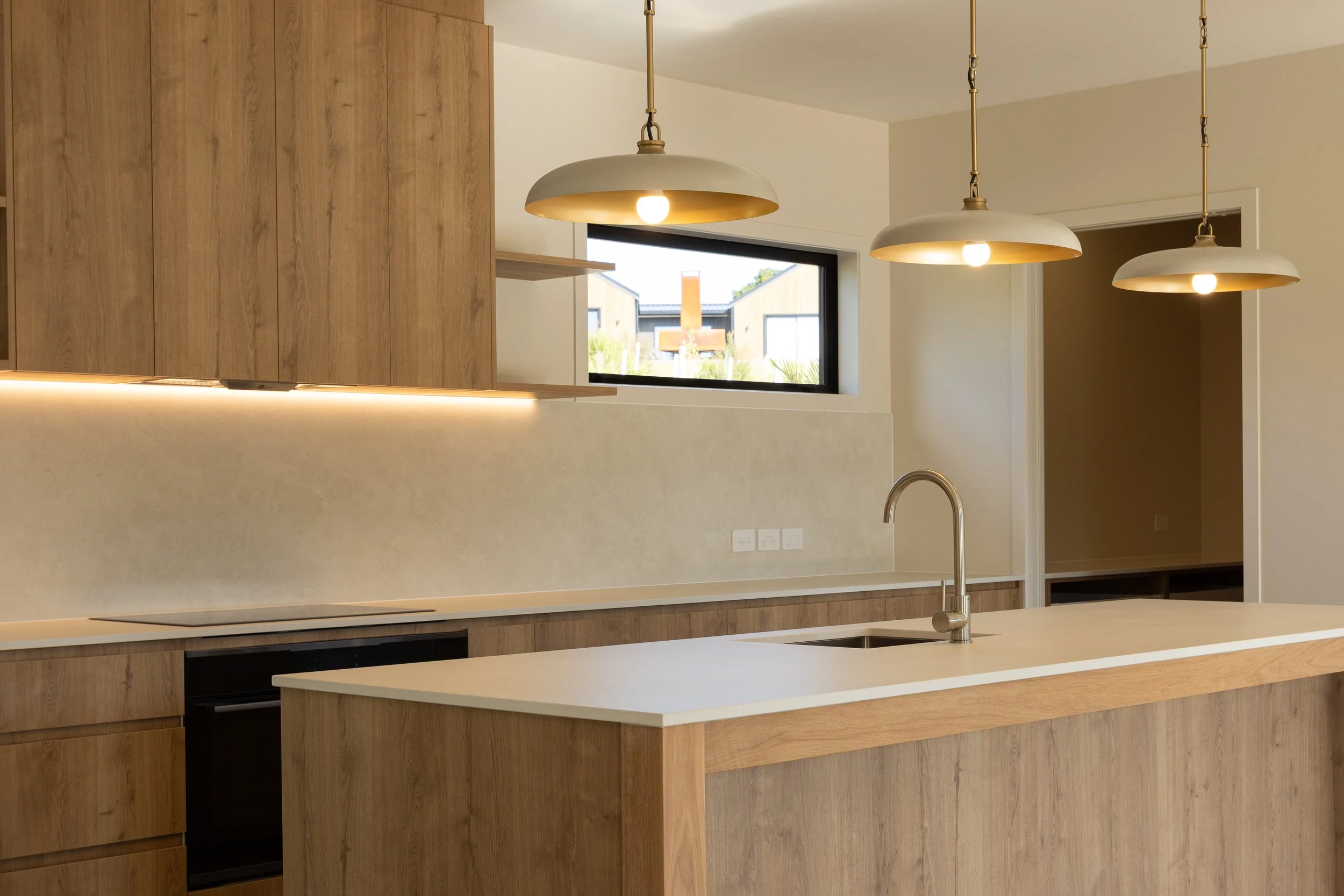 Kitchen and dining area in contemporary Mangawhai family home.