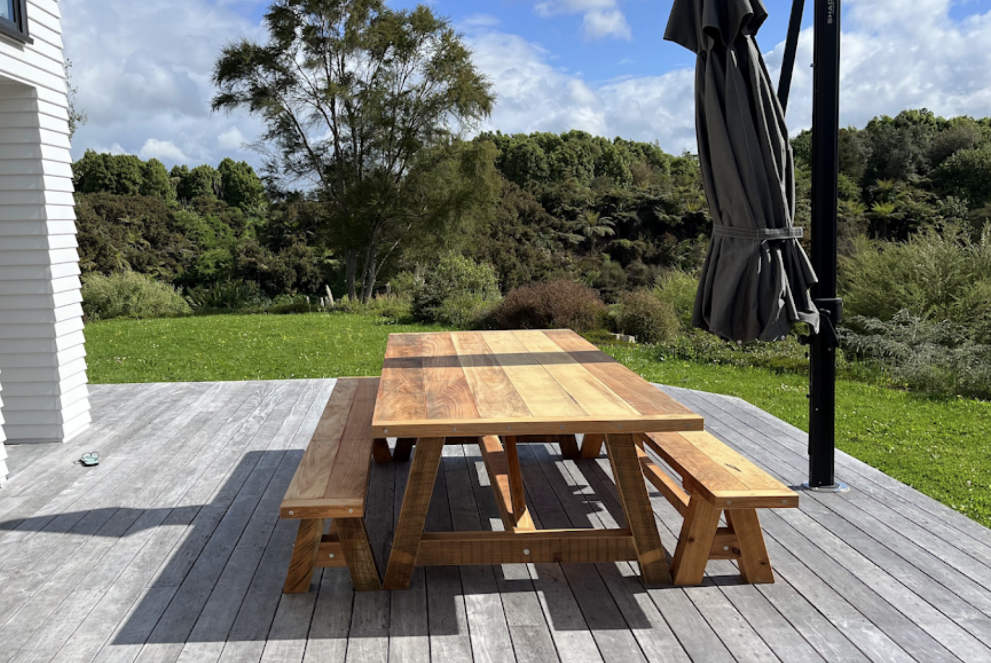 Handcrafted Macrocarpa dining table by Benchmark Build in a customer’s home.