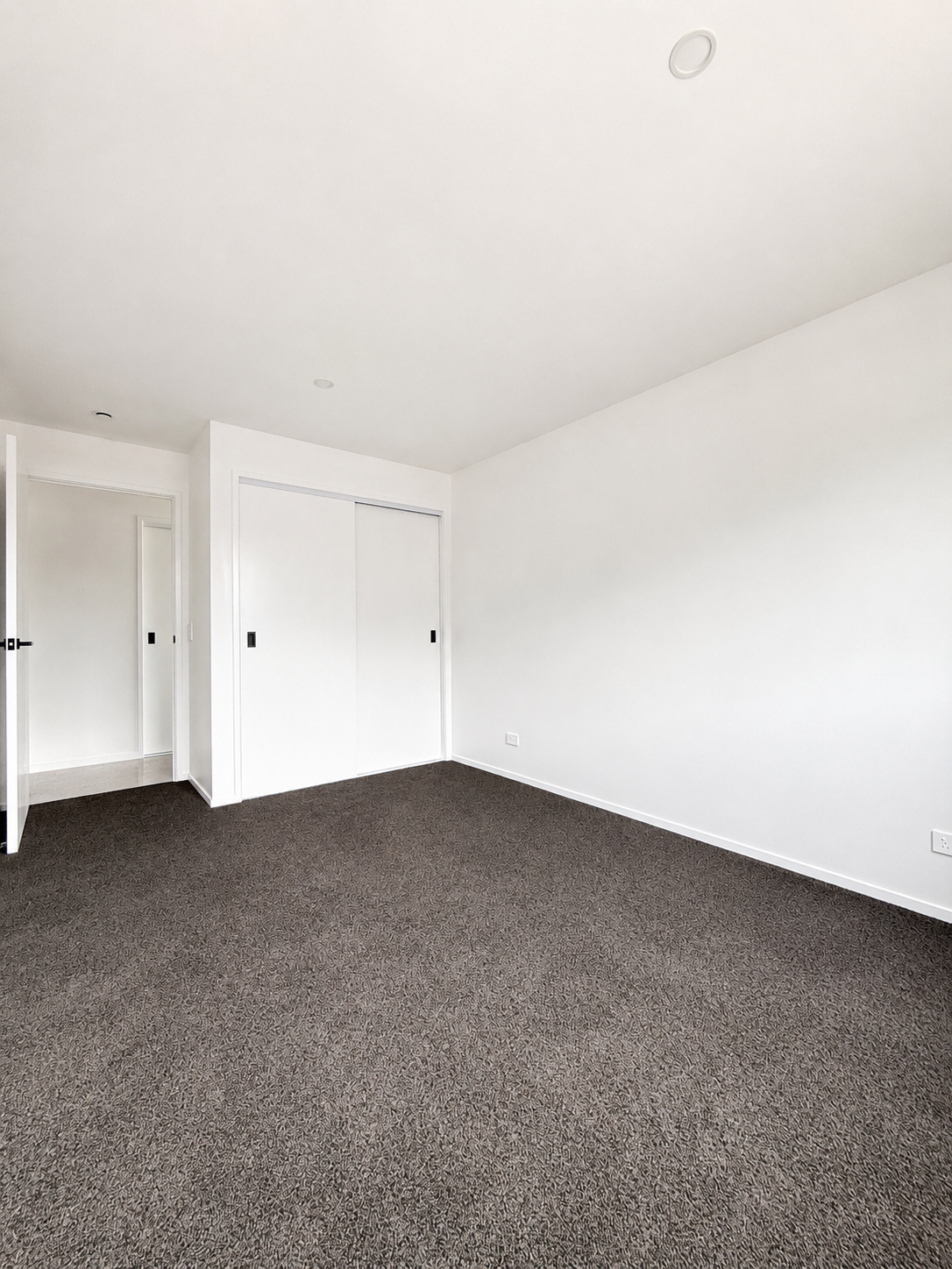 Modern bedroom in completed Benchmark Build home in Mangawhai
