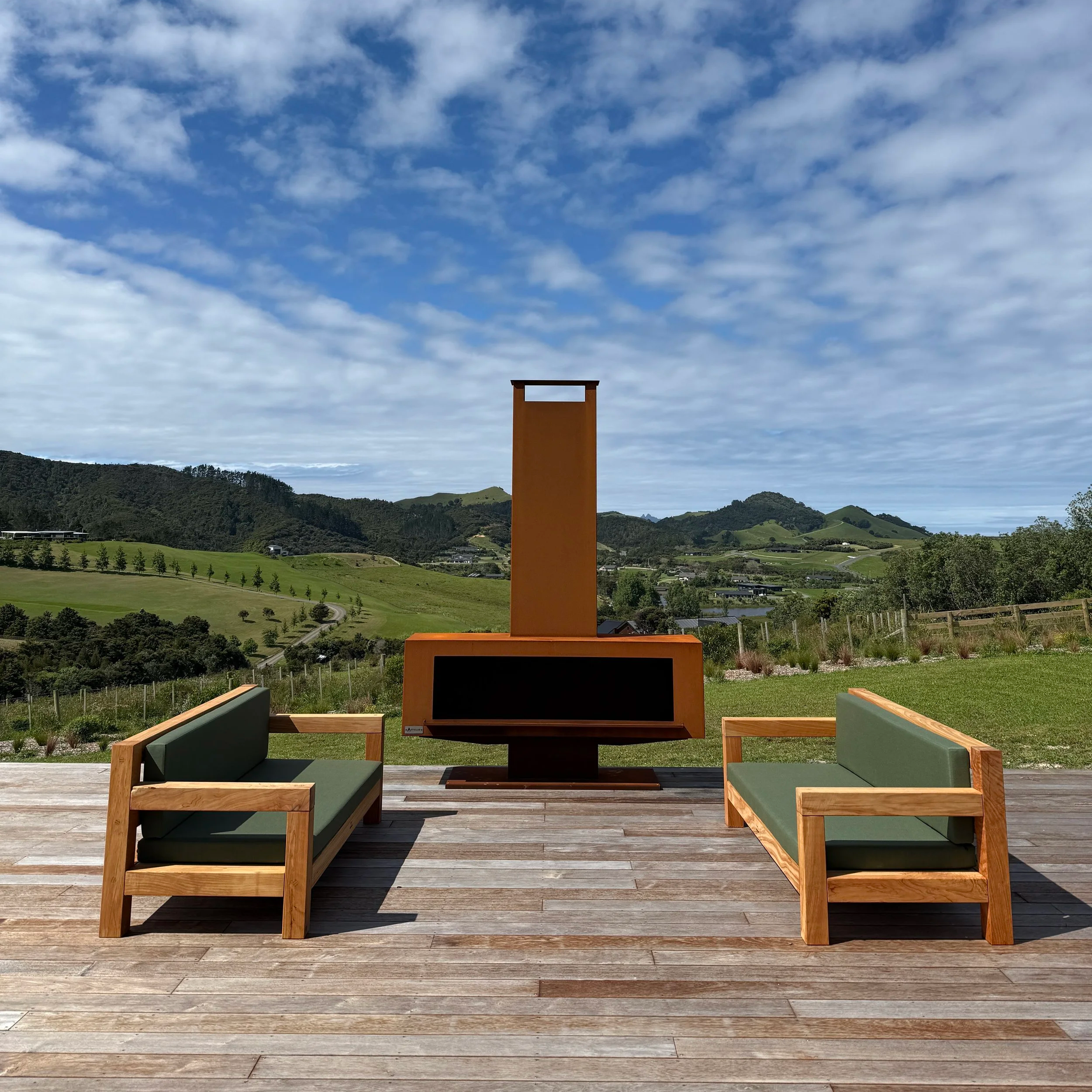 Three-seater Macrocarpa outdoor lounge with comfortable squab cushions, handcrafted in Mangawhai, New Zealand.
