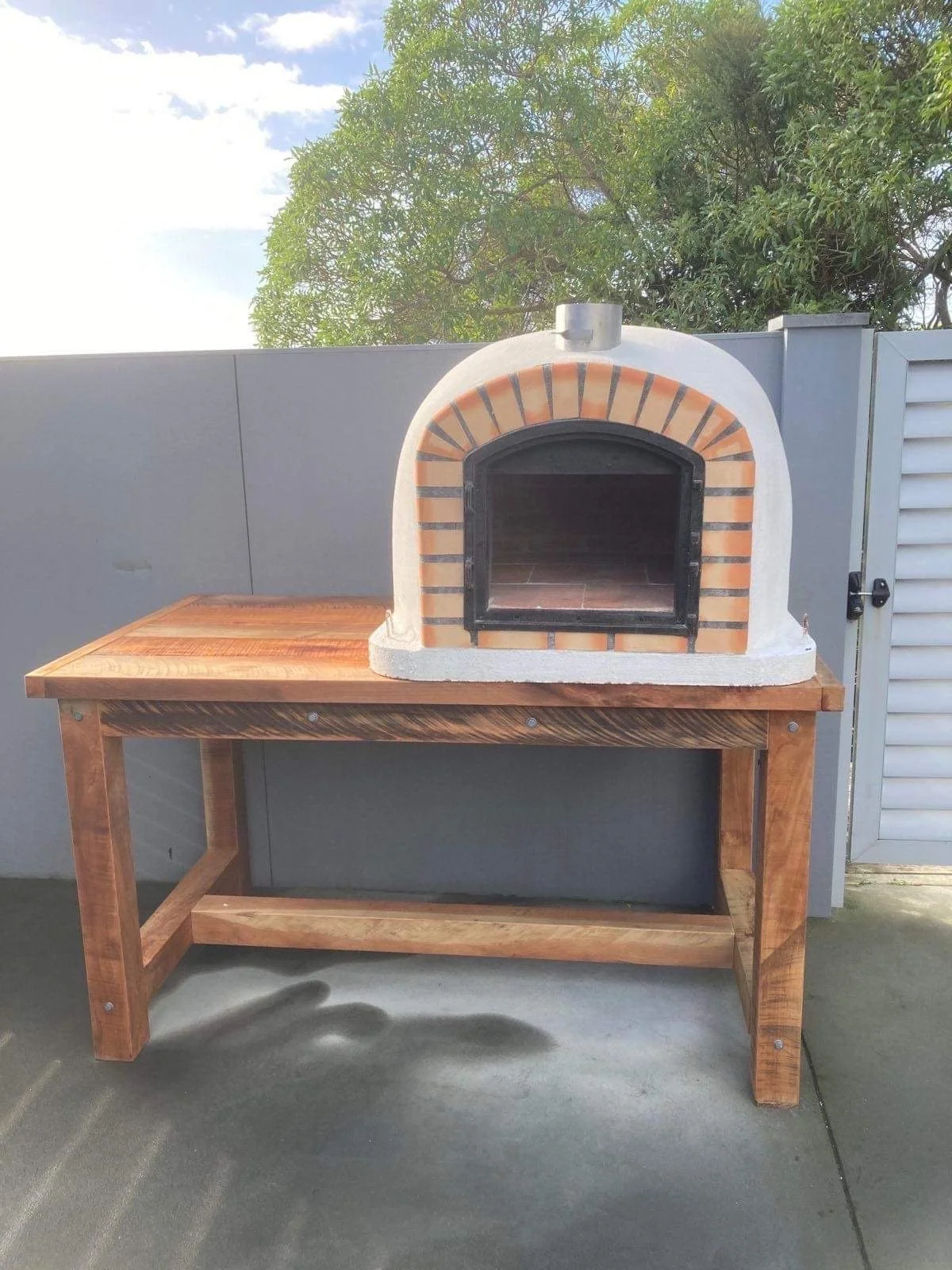 Custom Macrocarpa outdoor table built to support a pizza oven.