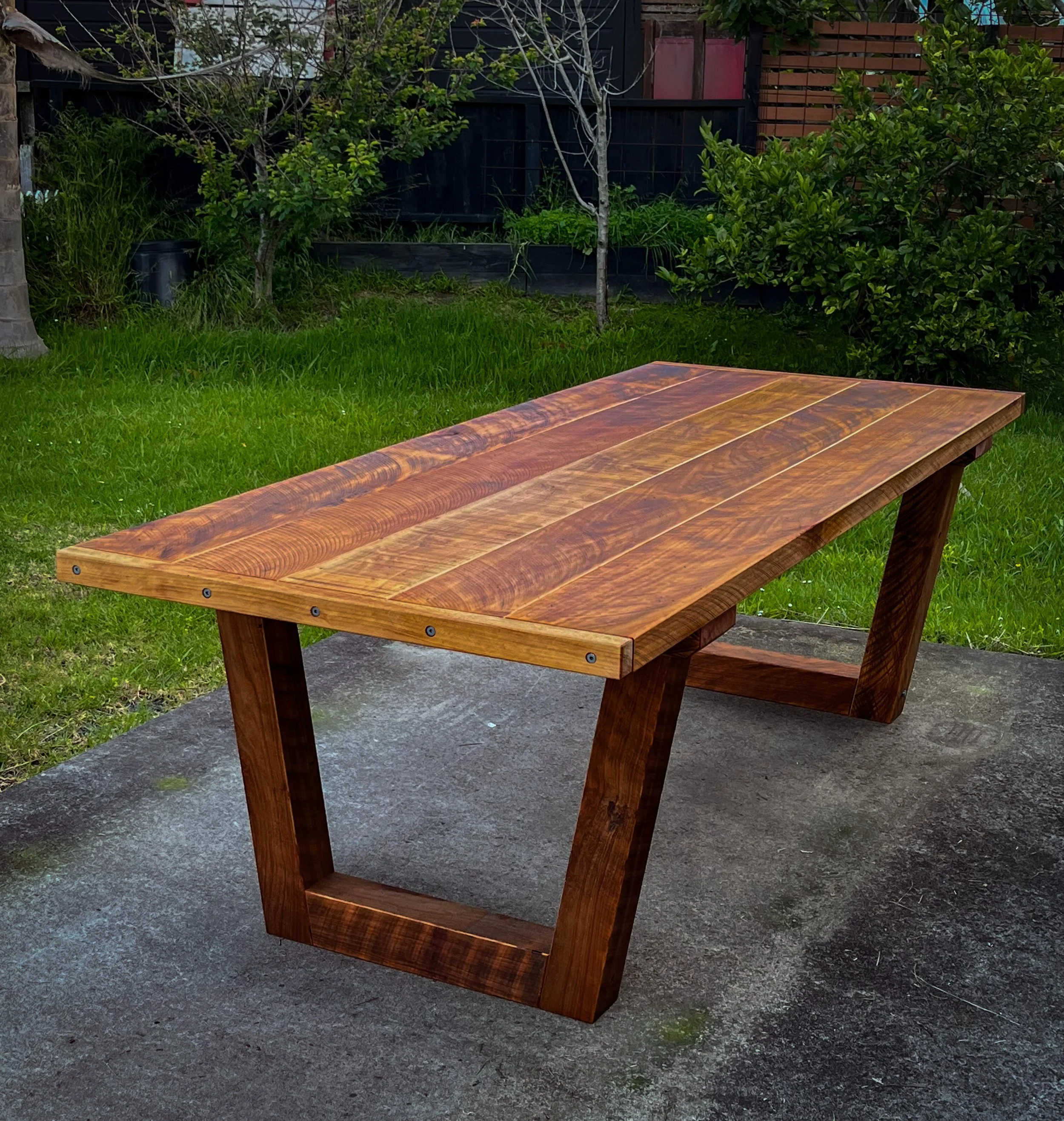 Handcrafted Macrocarpa dining table with solid timber legs.