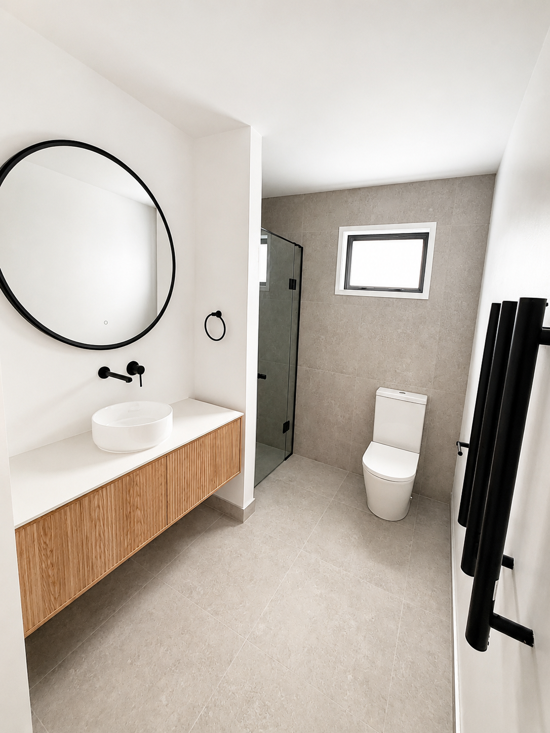 Modern bathroom in completed Benchmark Build home in Mangawhai.