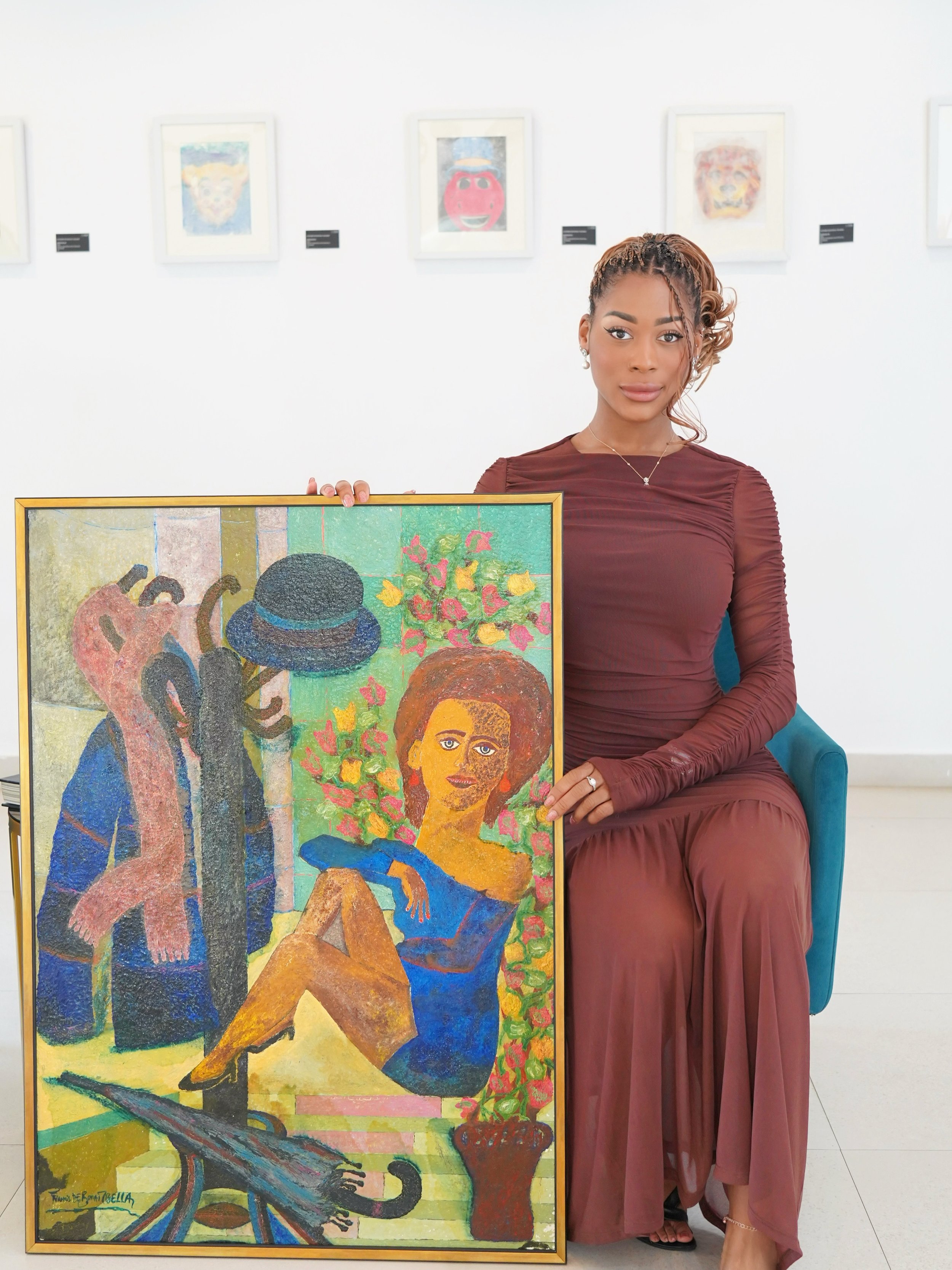 Joy Mbella presenting a contemporary artwork by Francis Mbella as part of the TPC Art House collection.