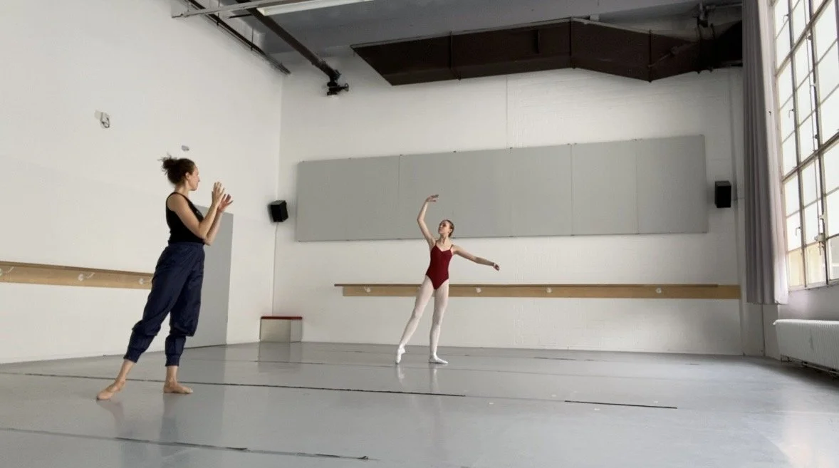 Ballet teacher working with ballet student in a professional studio