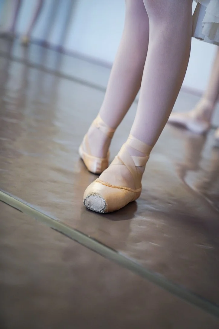 Close-up of a ballet dancer in pointe shoes during studio training.