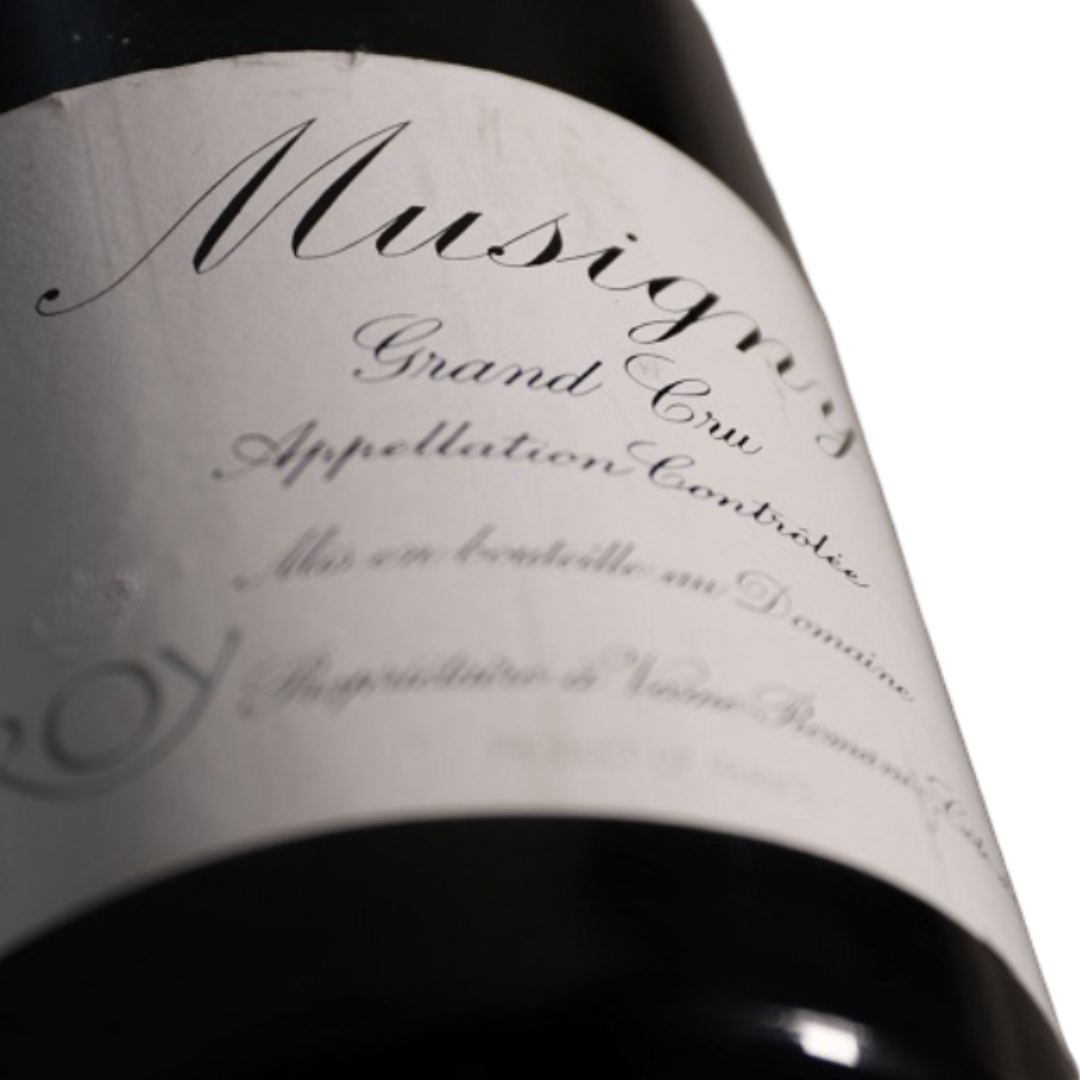 Close-up of a wine bottle label reading 'Music' and 'Grand Cru Appellation Controllée' in cursive script.