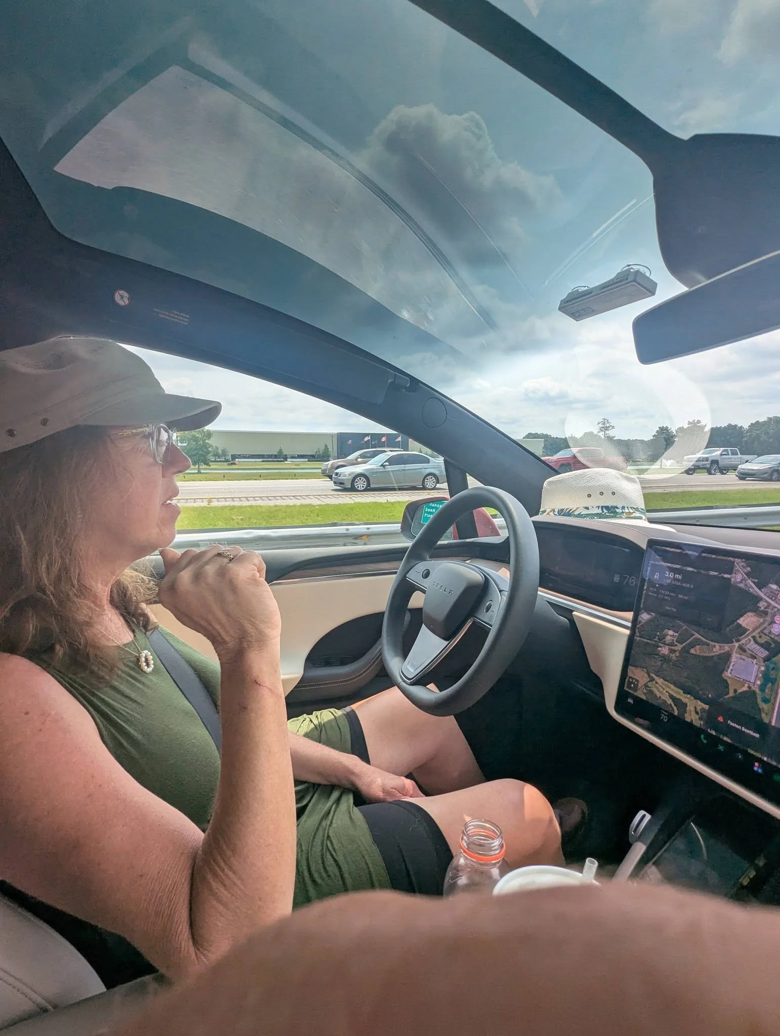 Gina riding in the driver’s seat of a Tesla operating in Full Self-Driving mode during a road trip.