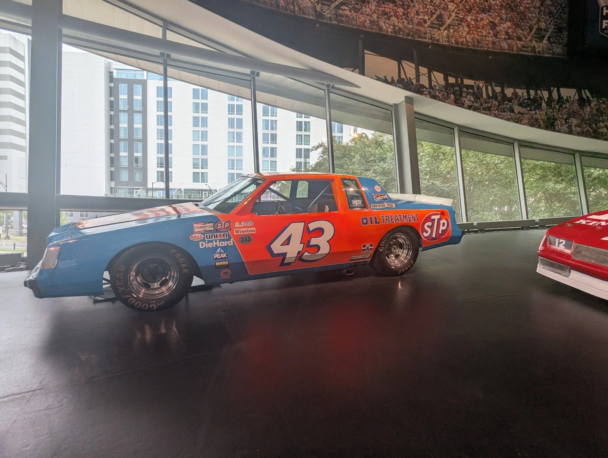 Richard Petty's blue-and-red No. 43 STP NASCAR race car displayed on Glory Road at the NASCAR Hall of Fame in Charlotte.