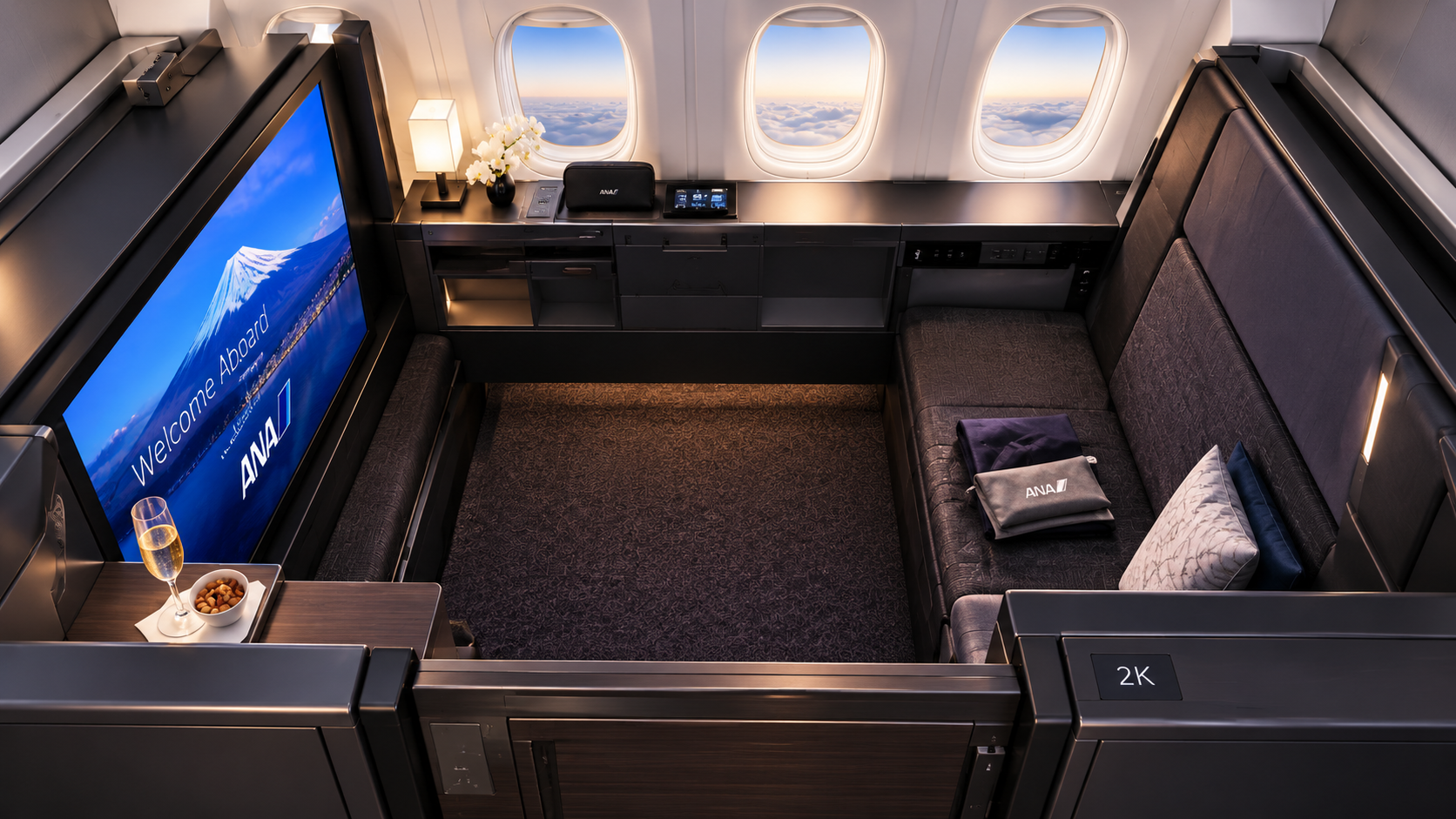 Conceptual illustration of ANA THE Suite First Class on a Boeing 777-300ER with a large private seating area and entertainment screen.