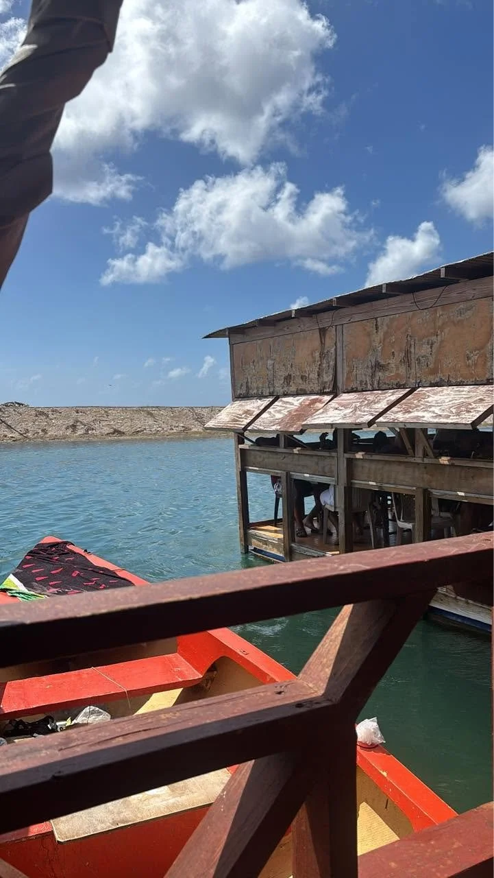 Rustic floating seafood restaurant in a working marina near Willemstad, Curaçao, recommended by a local resident.