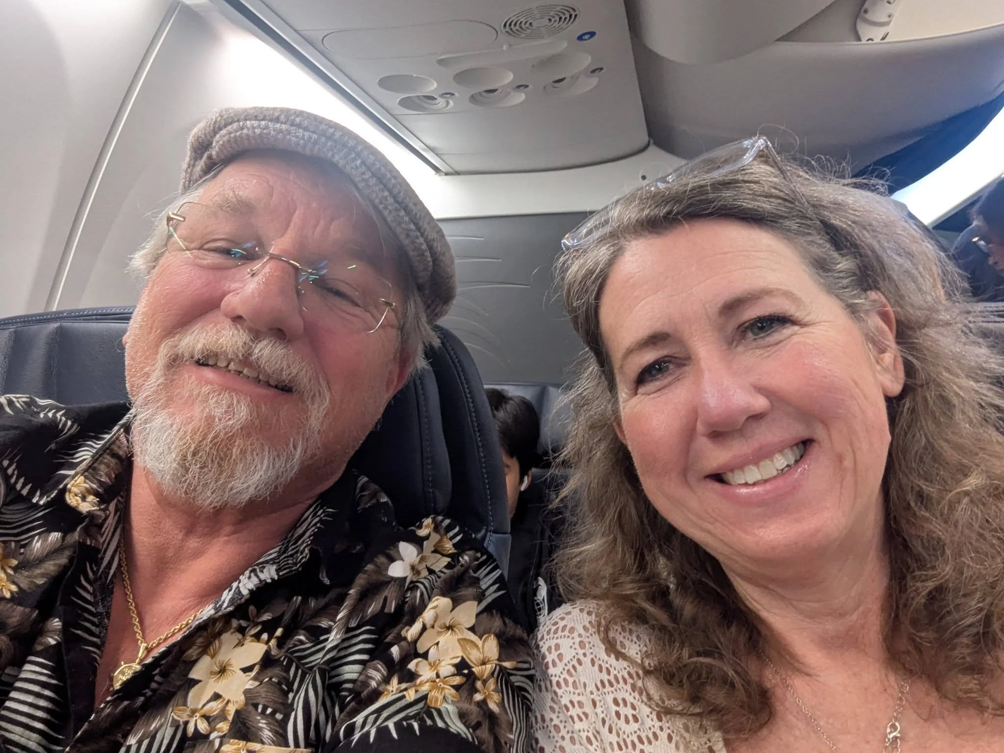 Brian and Gina of Curated Upgrades seated aboard a flight to Panama
