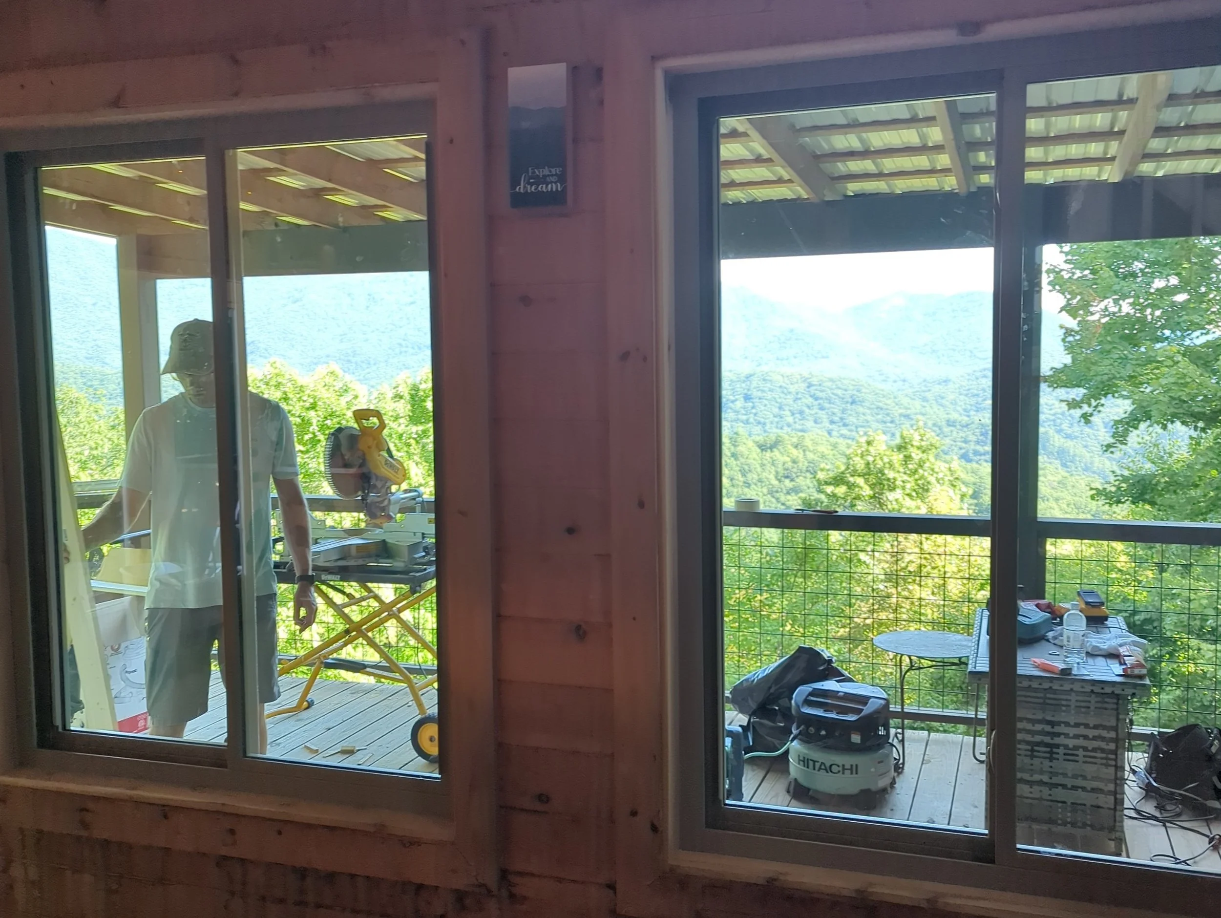 A window contractor working outside a North Carolina mountain cabin where a conversation about traveling to Australia began.