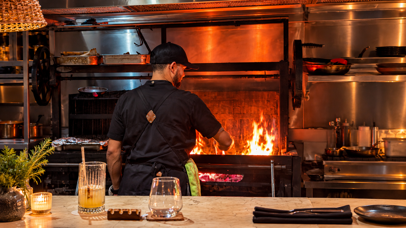 Chef cooking over the open-fire grill at Kaandela restaurant in Casco Viejo, Panama City.