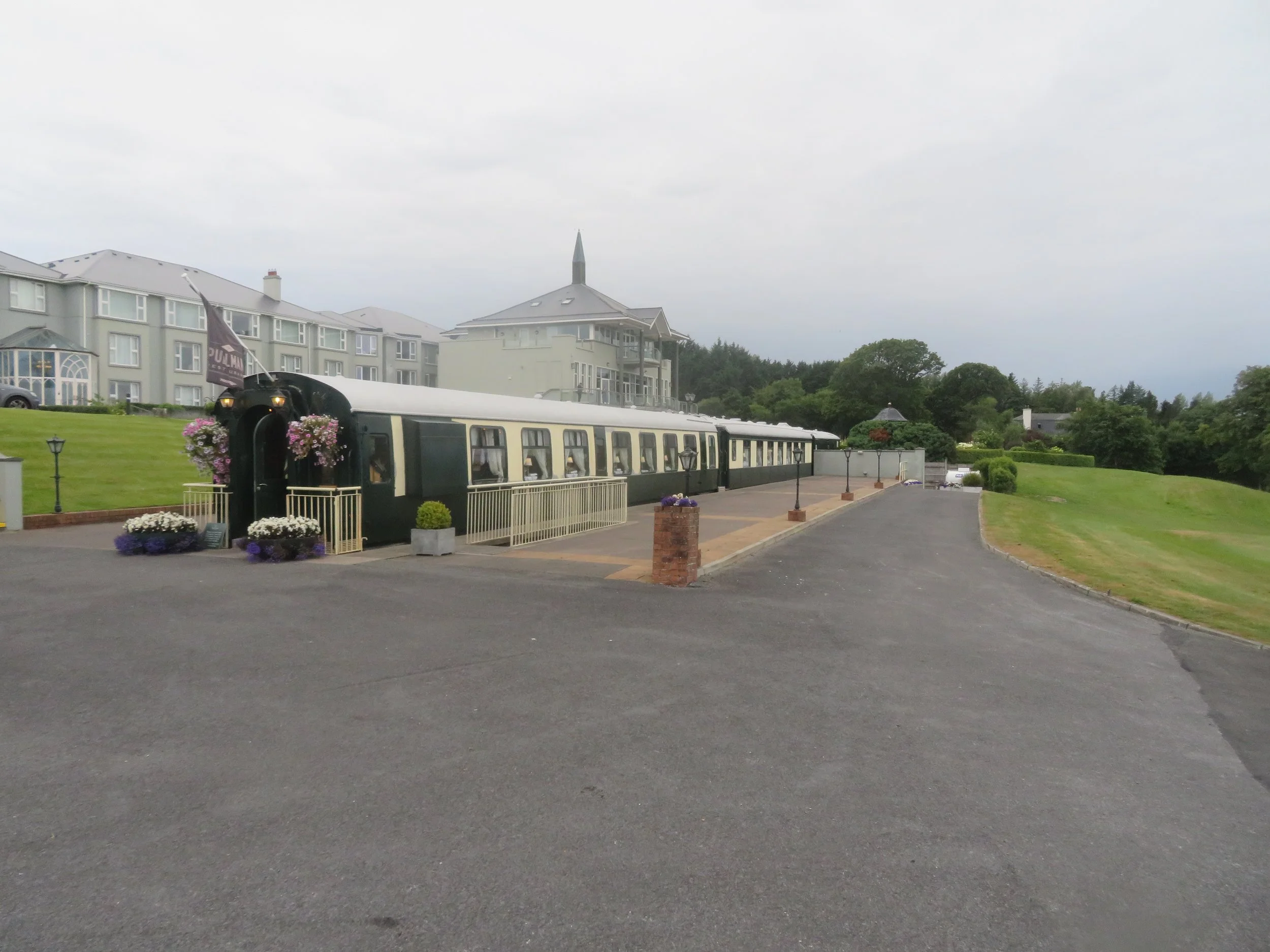 Historic Pullman Restaurant railway carriages with Glenlo Abbey Hotel & Estate in the background near Galway, Ireland.