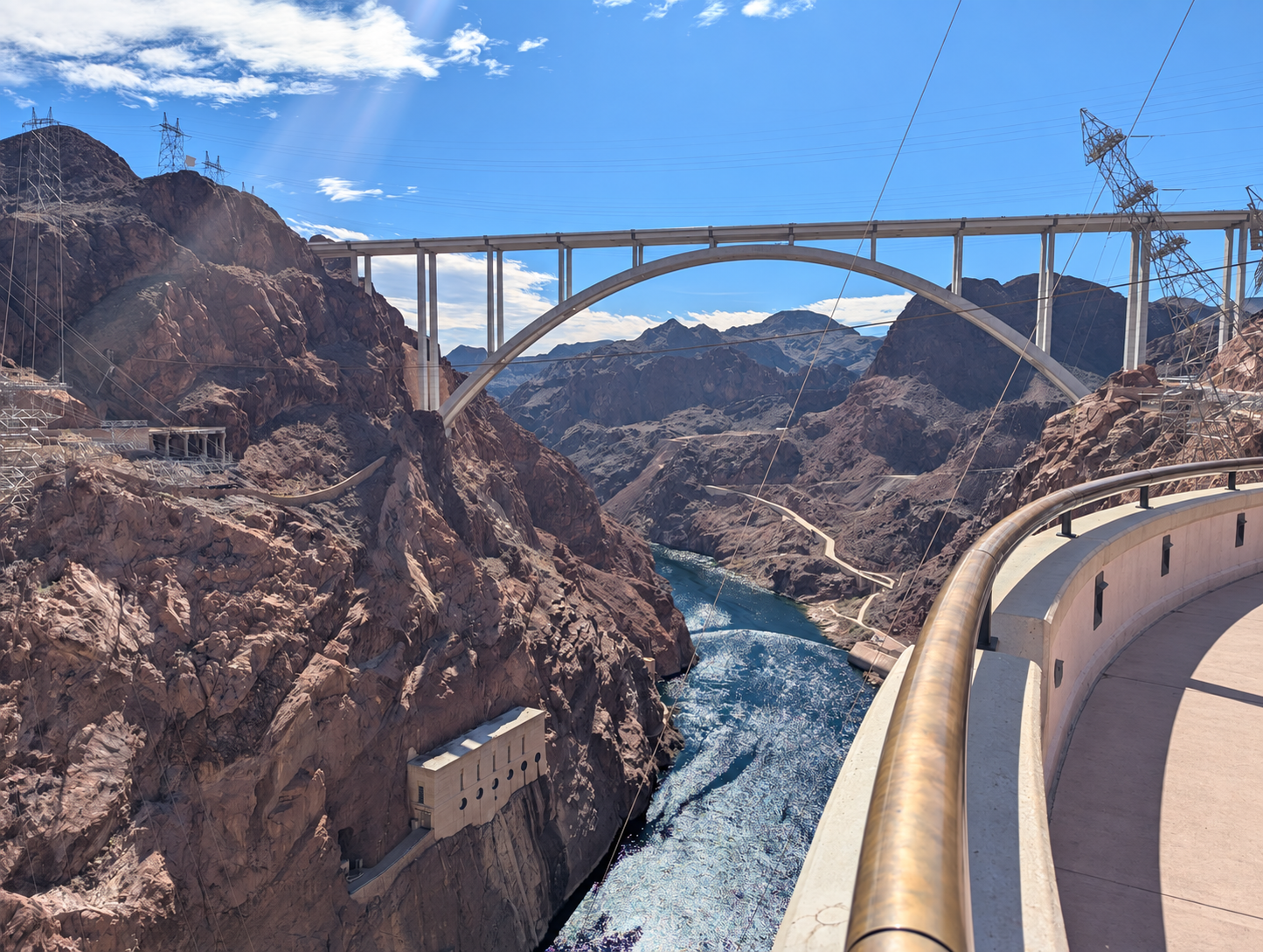 Hoover Dam with the canyon and memorial bridge behind it in the background
