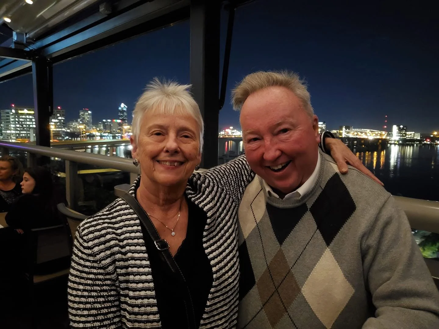 Older married couple smiling together while traveling, illustrating the importance of making time for travel with aging parents.