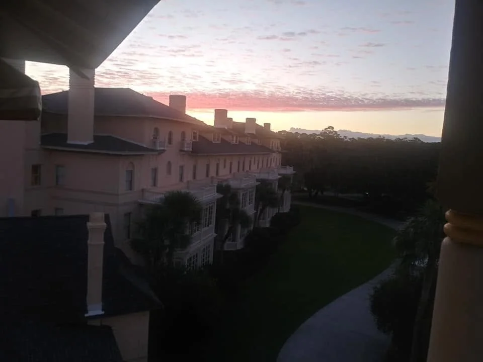 Pink and gold sunset over the historic Jekyll Island Club Resort, photographed from the couple's hotel room.