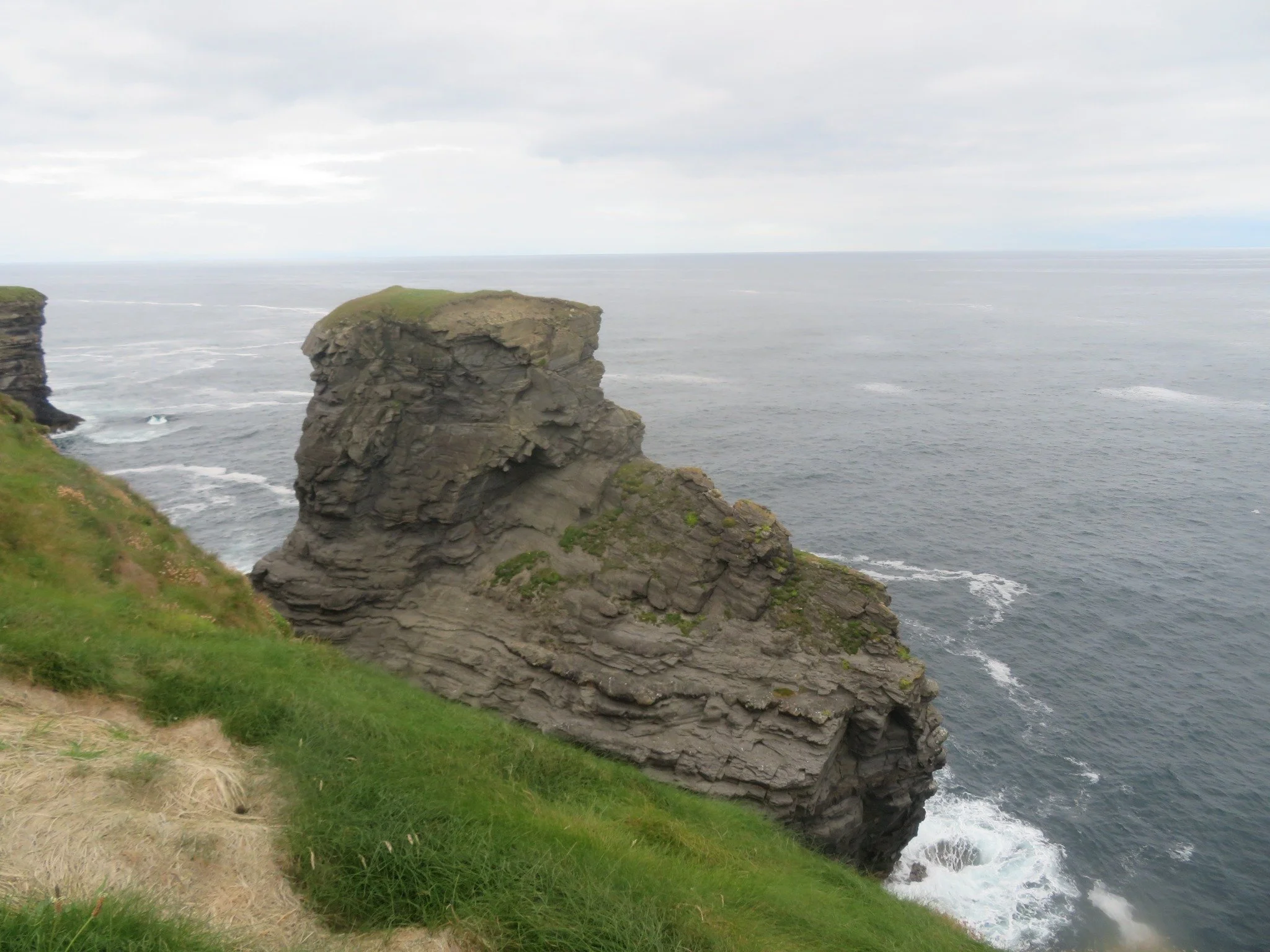 Rugged rock formation rising above the Atlantic along the Kilkee Cliffs in County Clare, Ireland