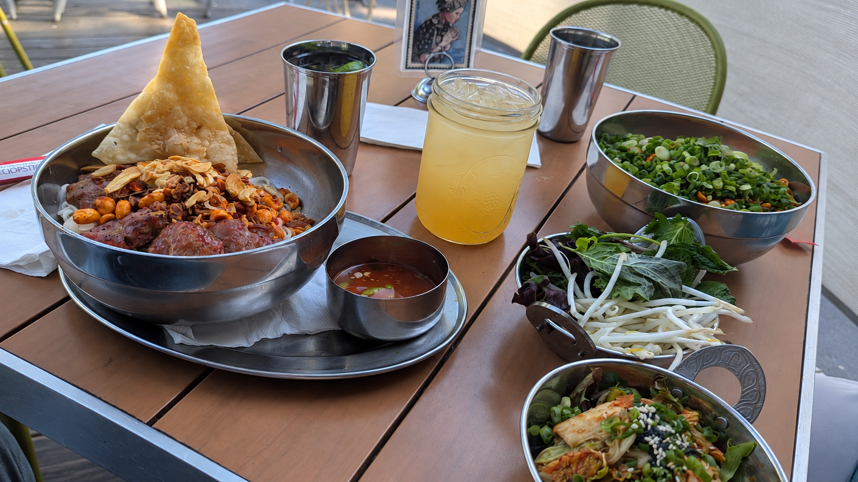 Globally inspired noodle dishes, fresh herbs, and drinks served on the outdoor patio at Spork in Bend, Oregon.