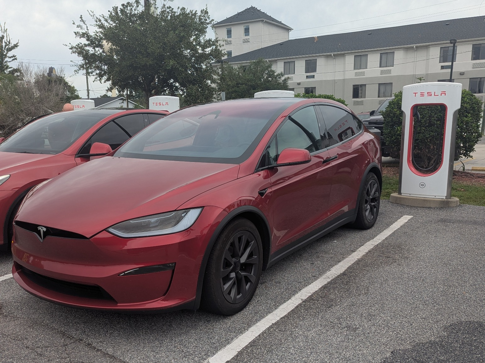 Our red Tesla Model X parked at a Tesla Supercharger in Orangeburg, South Carolina, during our 855-mile round trip to Charlotte Motor Speedway.