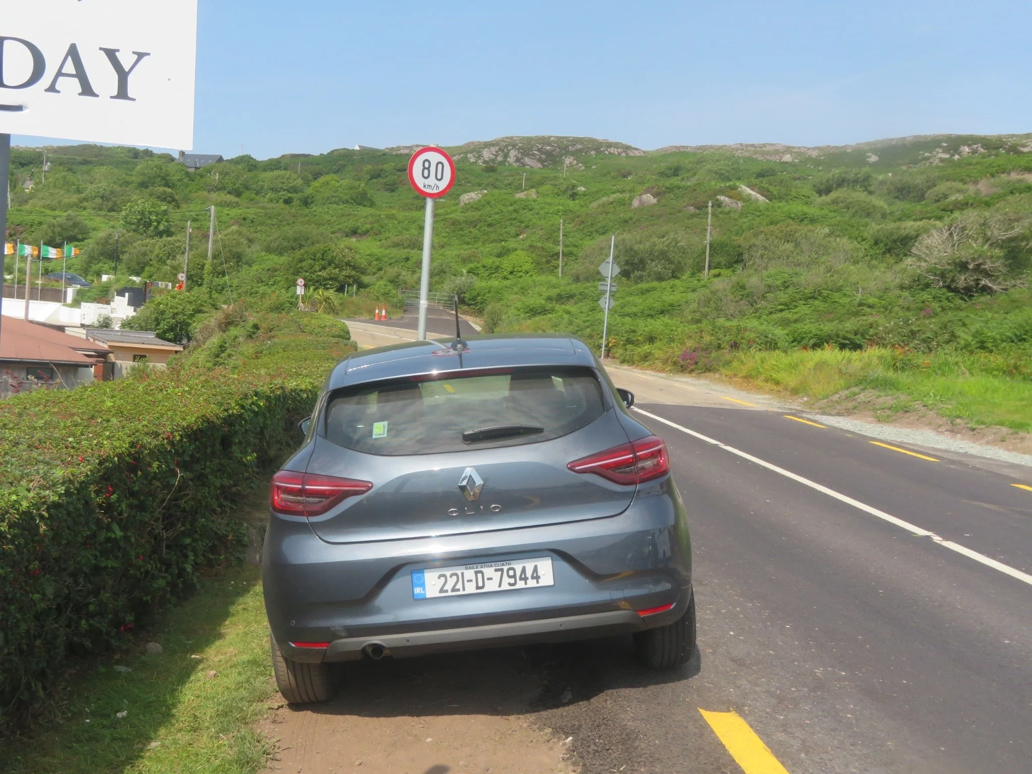 Our Renault Clio rental car parked beside an 80 km/h speed limit sign during our Ireland road trip