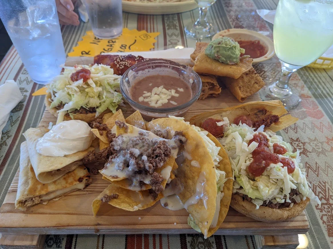 Large platter of tacos, tostadas, taquitos, tamale, beans and other Mexican dishes at La Hacienda III in Palatka, Florida.