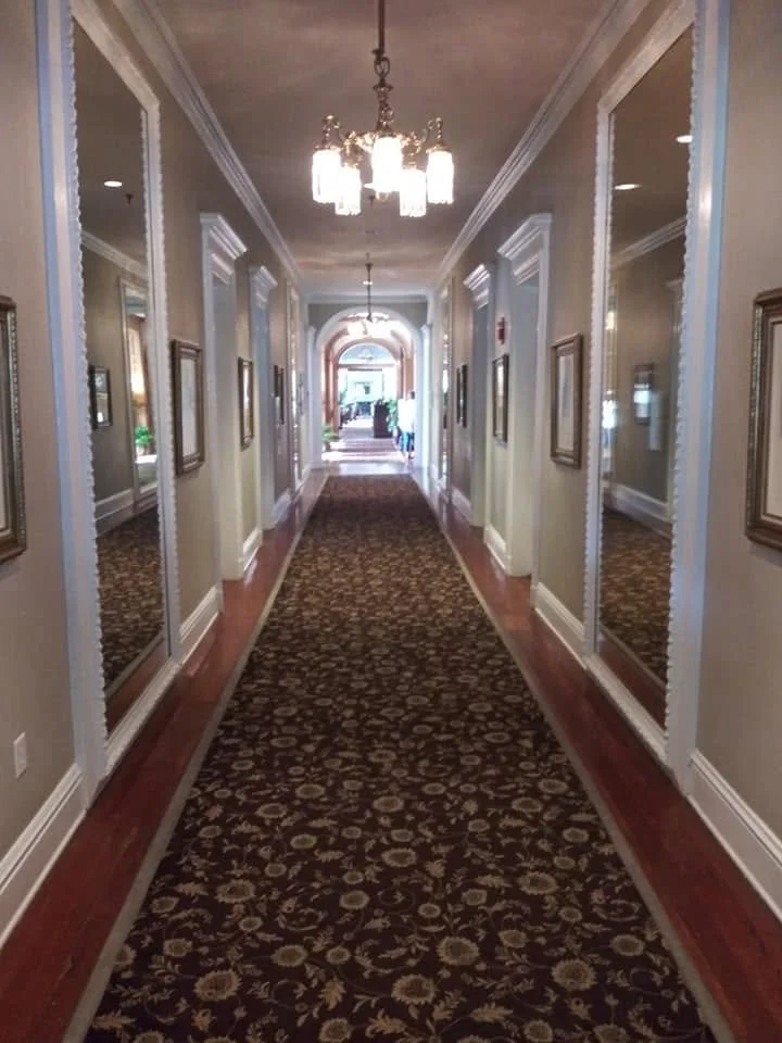 Historic interior hallway at the Jekyll Island Club Resort, showing traditional architectural details and the building's period character.