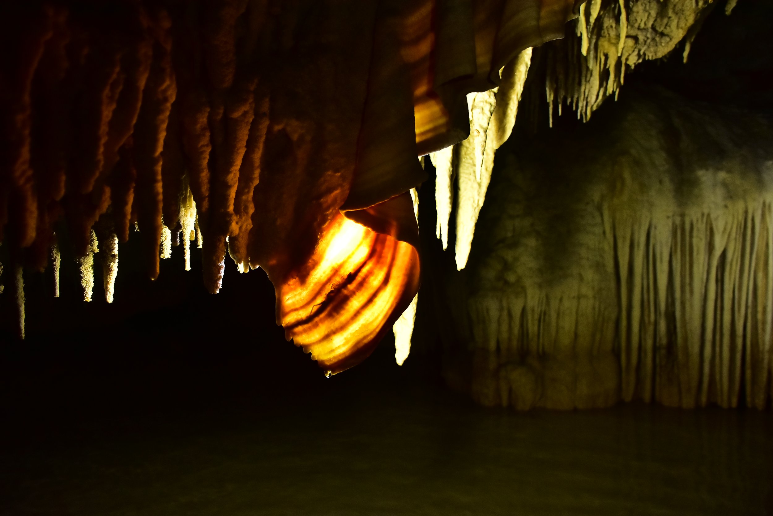 Illuminated stalactites and other formations inside Río Secreto.