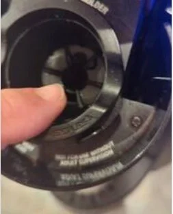 Close-up of the Keurig K-Cup holder, with a finger pointing to the component that had been incorrectly installed and was preventing the machine from brewing.