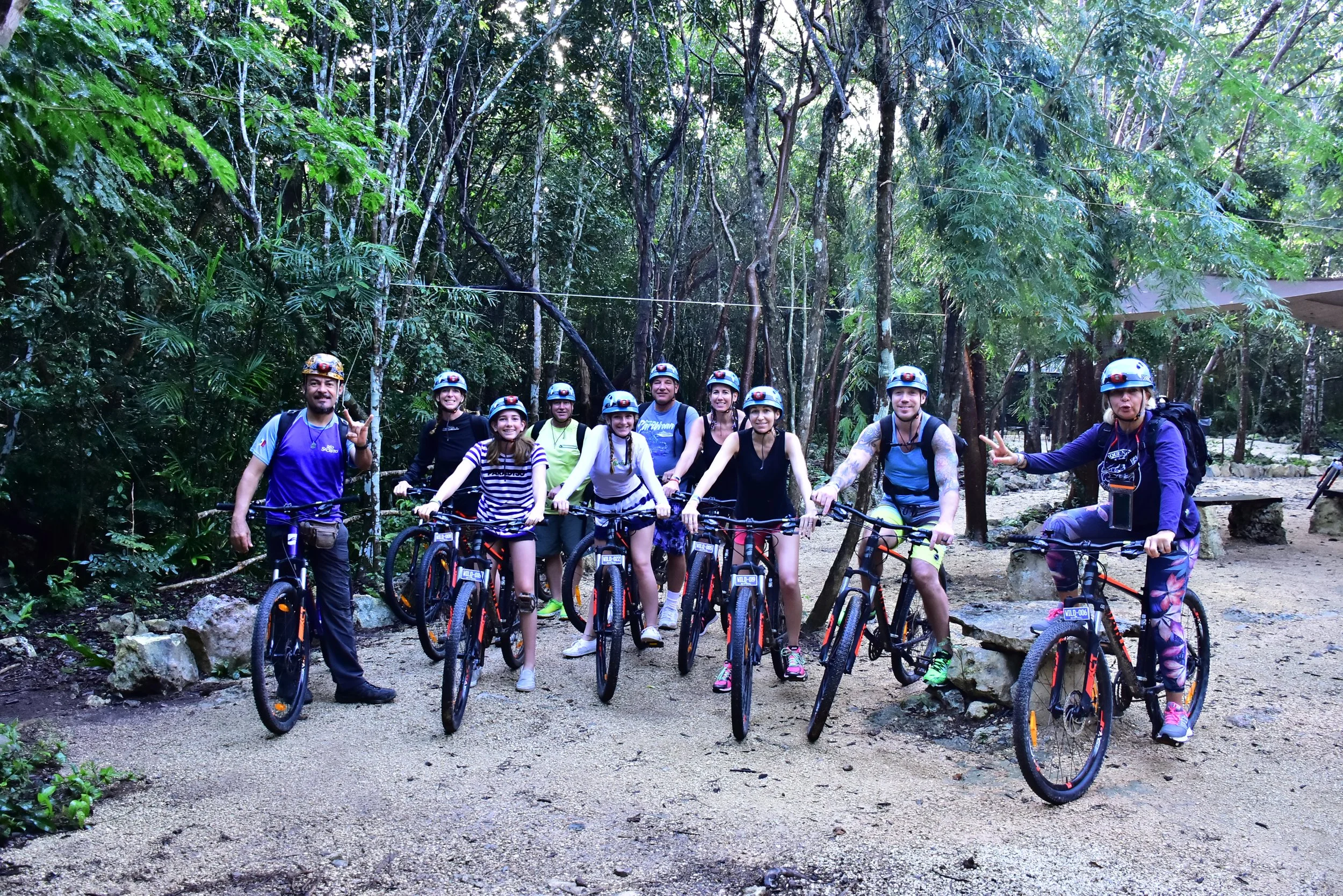 Brian and Gina riding mountain bikes through the Río Secreto nature reserve in Mexico.