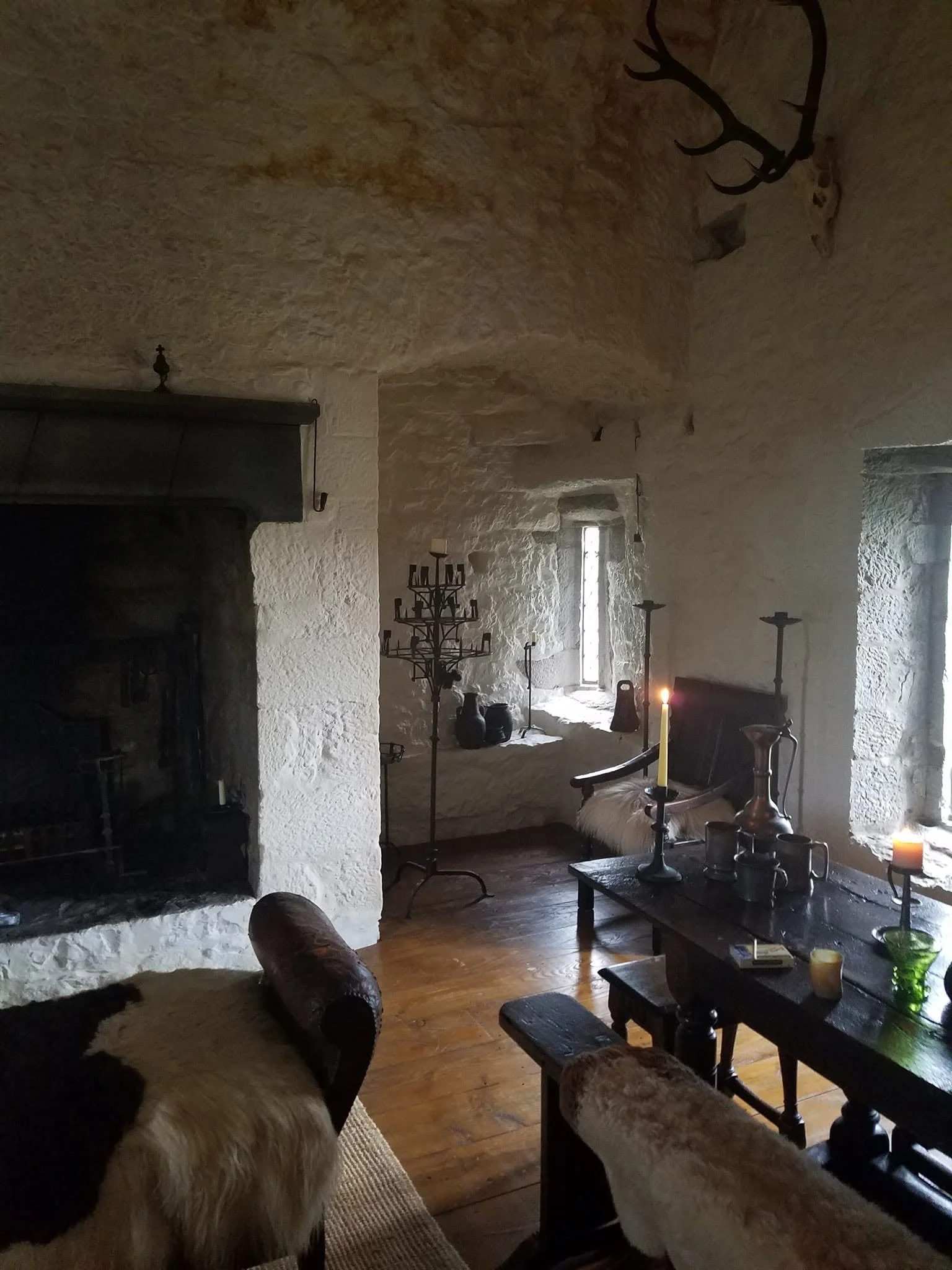 Candlelit Great Hall inside Black Castle, a restored historic tower house in County Tipperary, Ireland