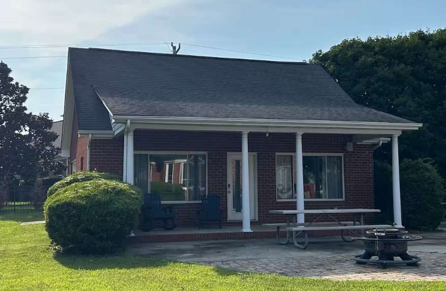Exterior of the brick pool house Airbnb in Harrisburg, North Carolina, where we stayed during our Charlotte NASCAR weekend.