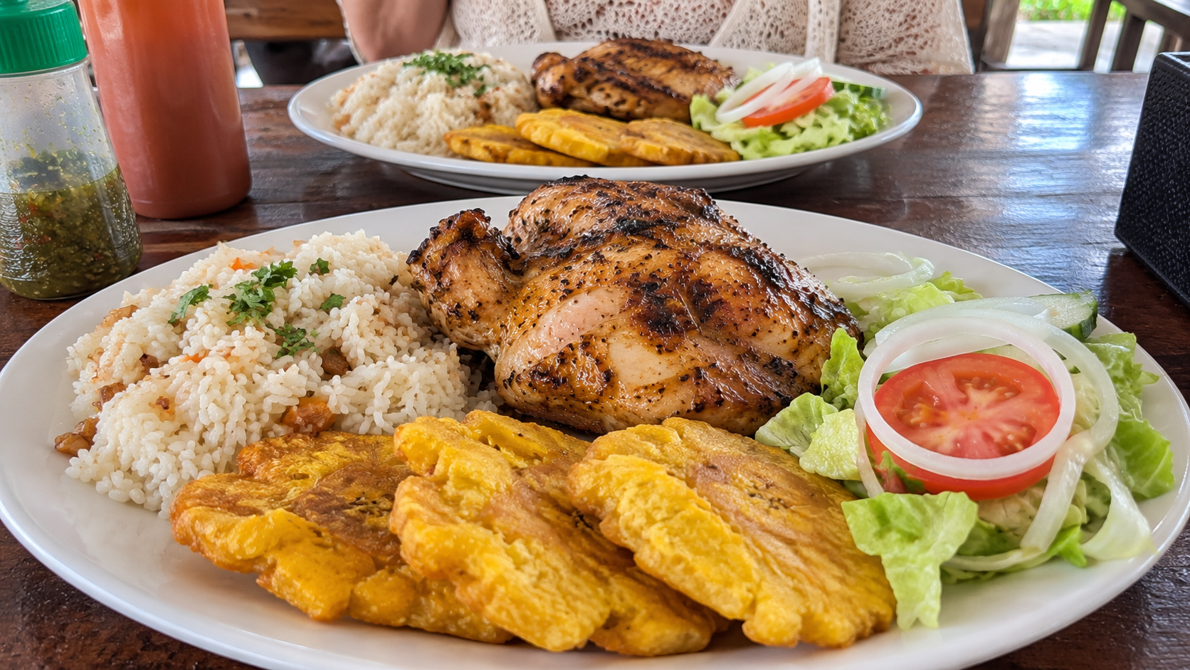 Plates of chicken, rice, plantains and corn cake served at a roadside fonda in Panama.