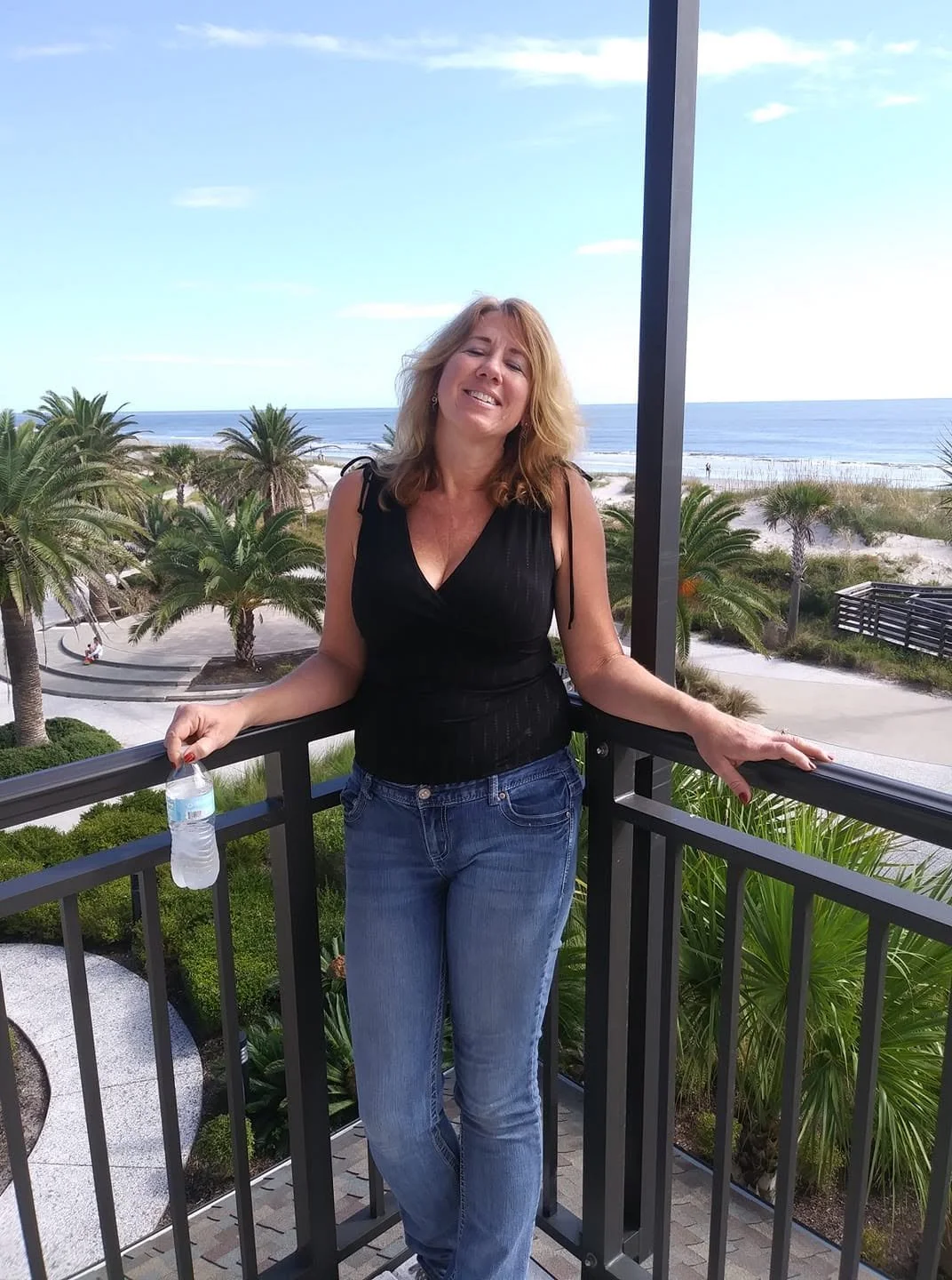 Gina enjoying the view from the balcony during our anniversary stay at the Jekyll Island Club Resort.