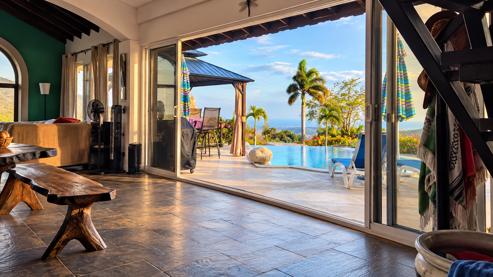 Open living area at Hawk’s Nest leading directly onto the patio, infinity pool and outdoor seating overlooking the mountains of Panama.