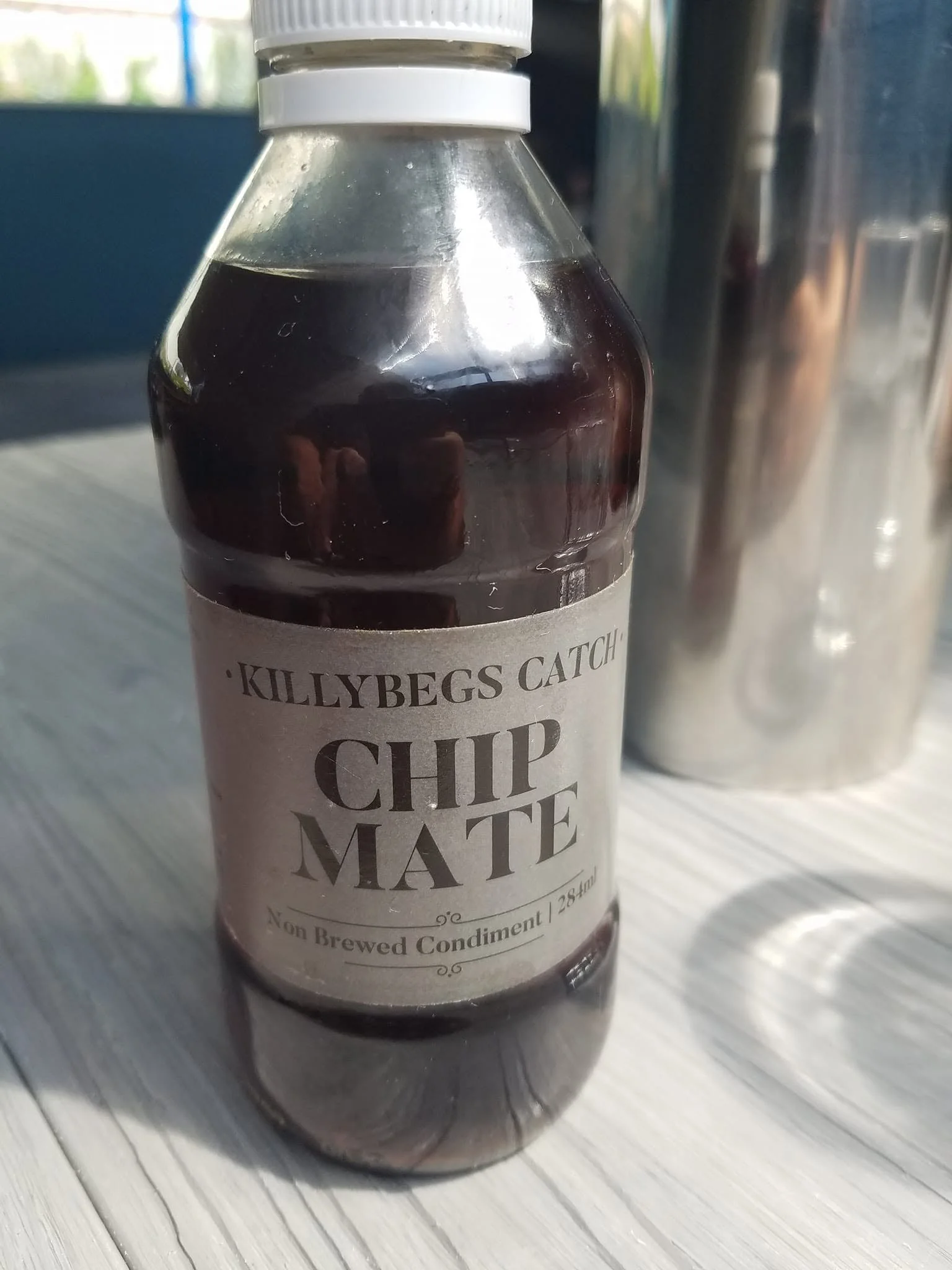 Bottle of Killybegs Catch Chip Mate served at The Fish Box in Dingle, Ireland.