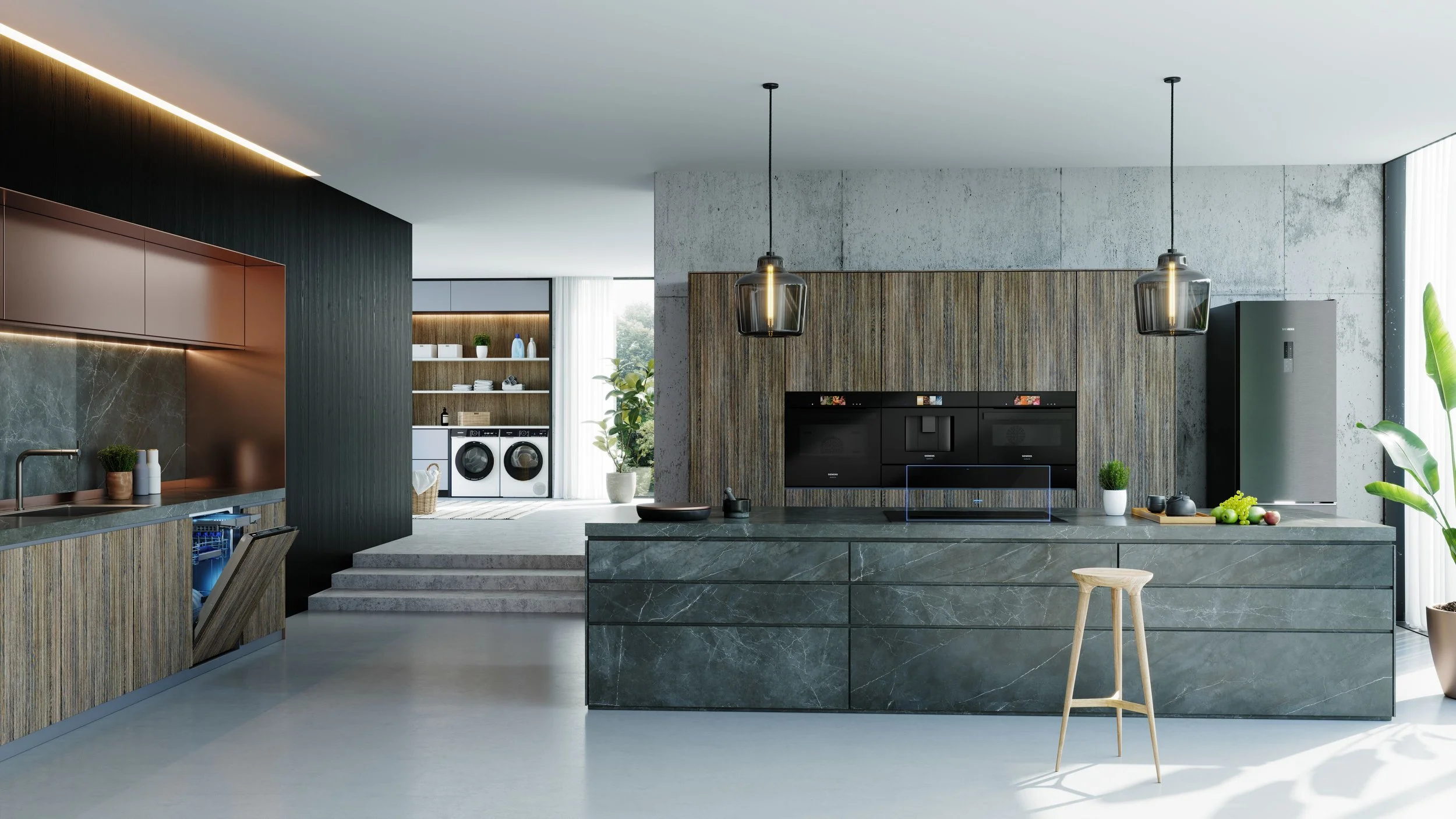 Modern kitchen with dark wood cabinets, marble island, pendant lights, and laundry area in the background.