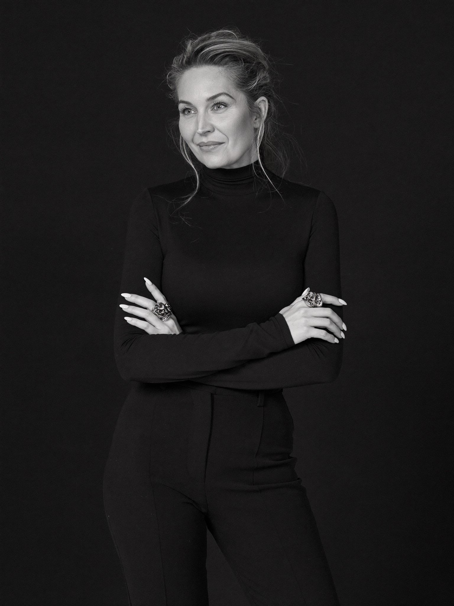 Editorial portrait of transformation mentor Brielle Fontaine smiling against a clean white studio background.